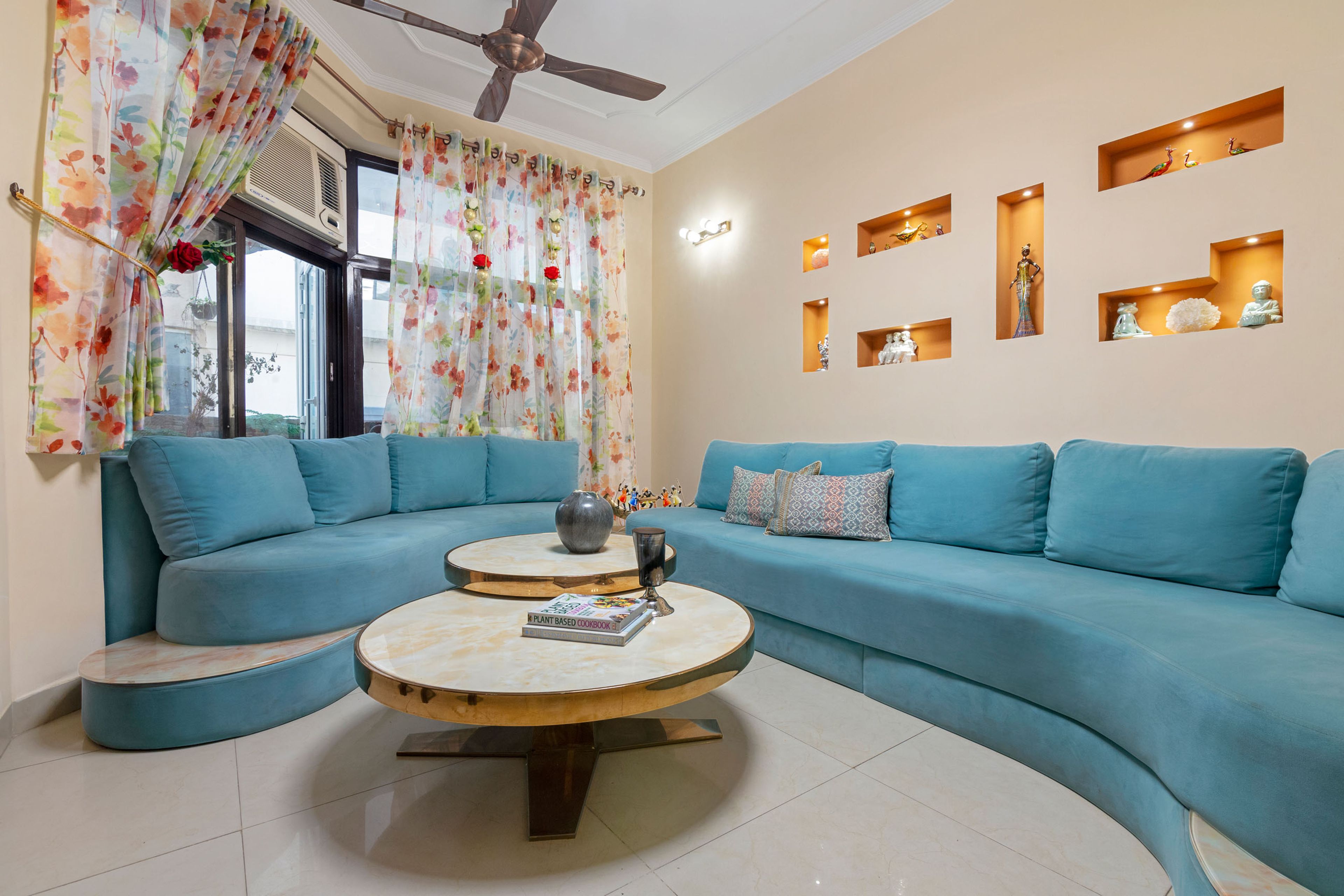 Minimalist Living Room Design with Blue Serpentine Sofa Set and Nesting Coffee Table - Livspace