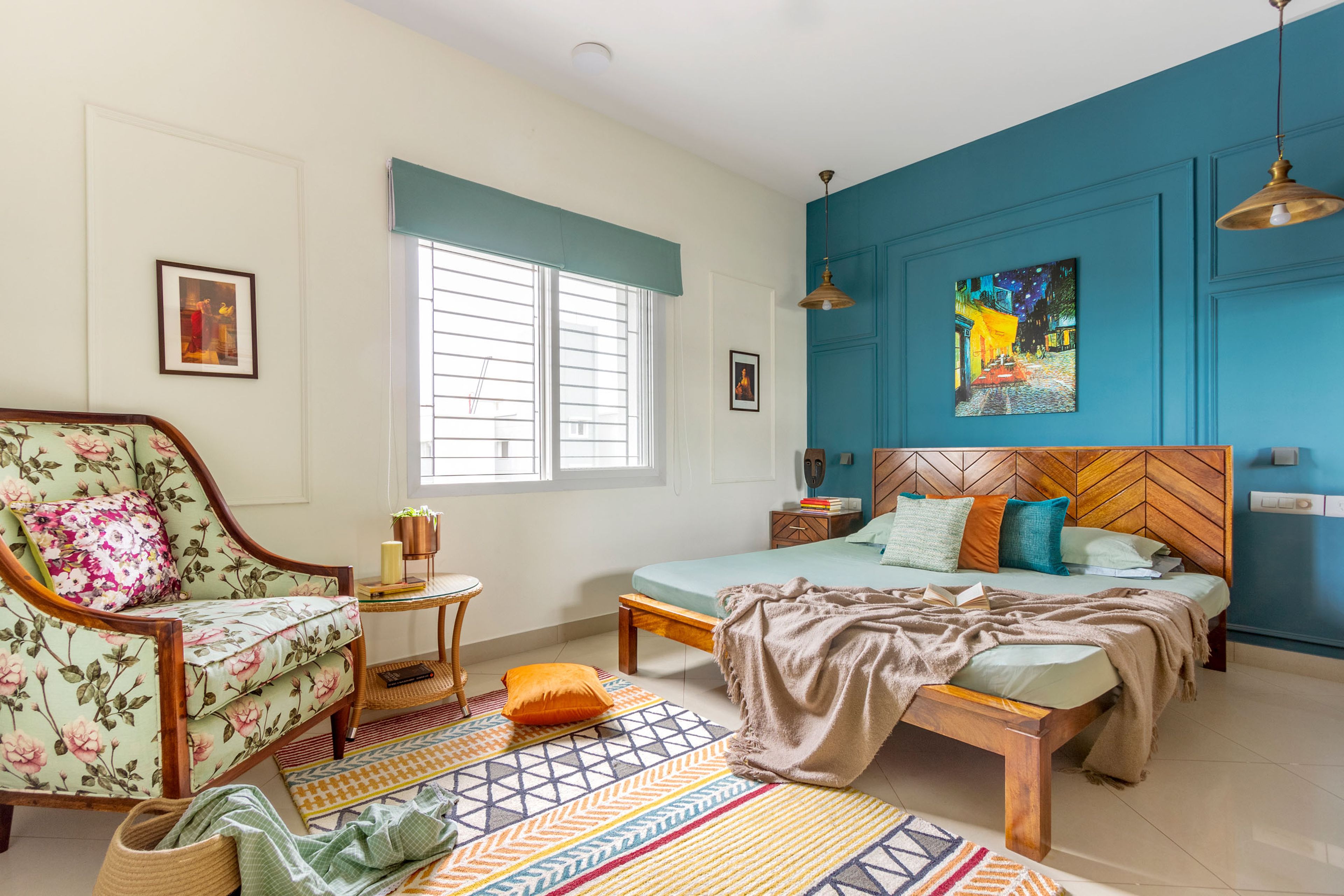 Contemporary Master Bedroom Design With Wooden Bed, Sliding Wardrobe, Floral Accent Wall, Wooden Side Table, and Round Cane Table - Livspace