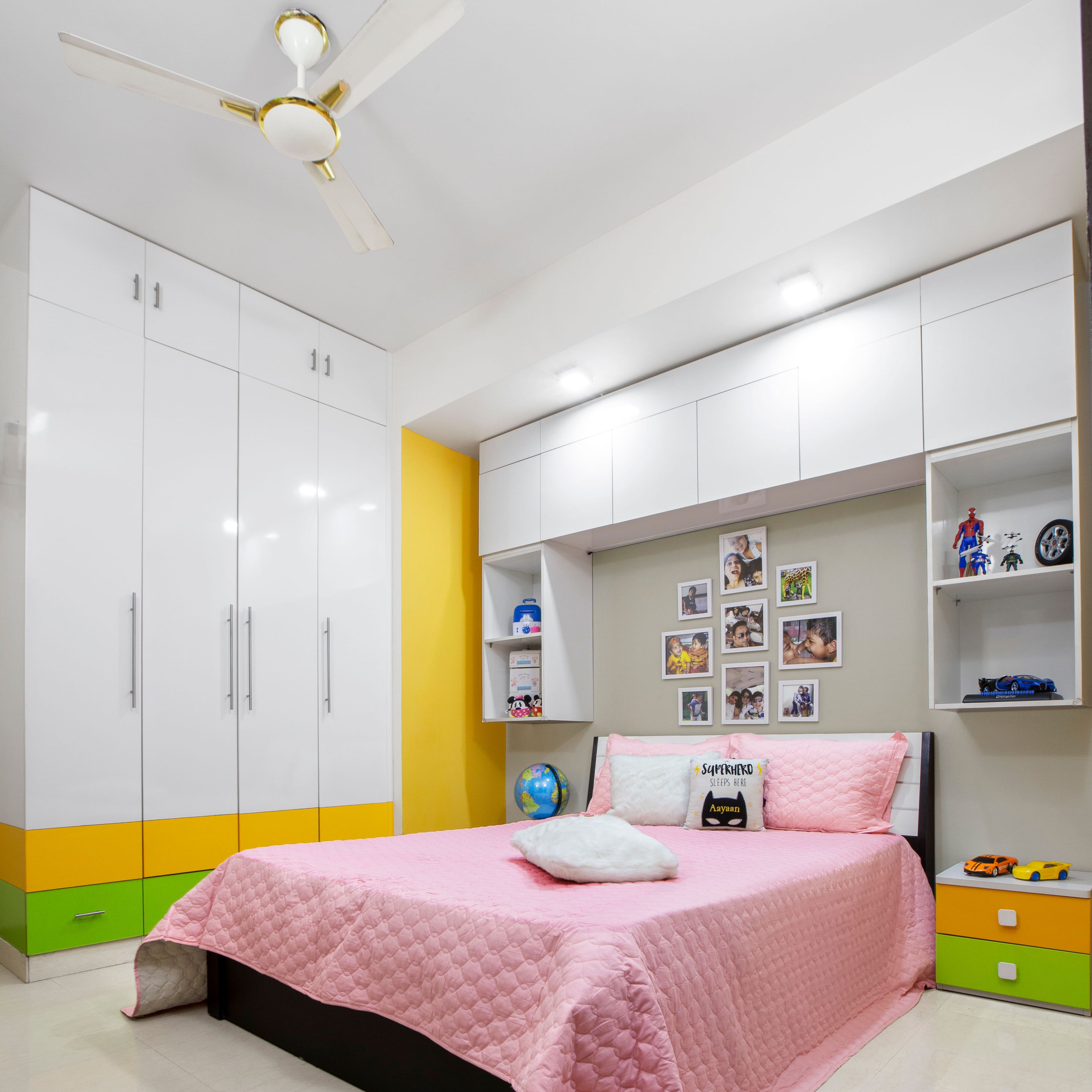 Space-Saving Kids Bedroom Design WIth Queen-Size Bed, Wall-Mounted Loft Storage And White Glossy 4-Door Swing Wardrobe - Livspace