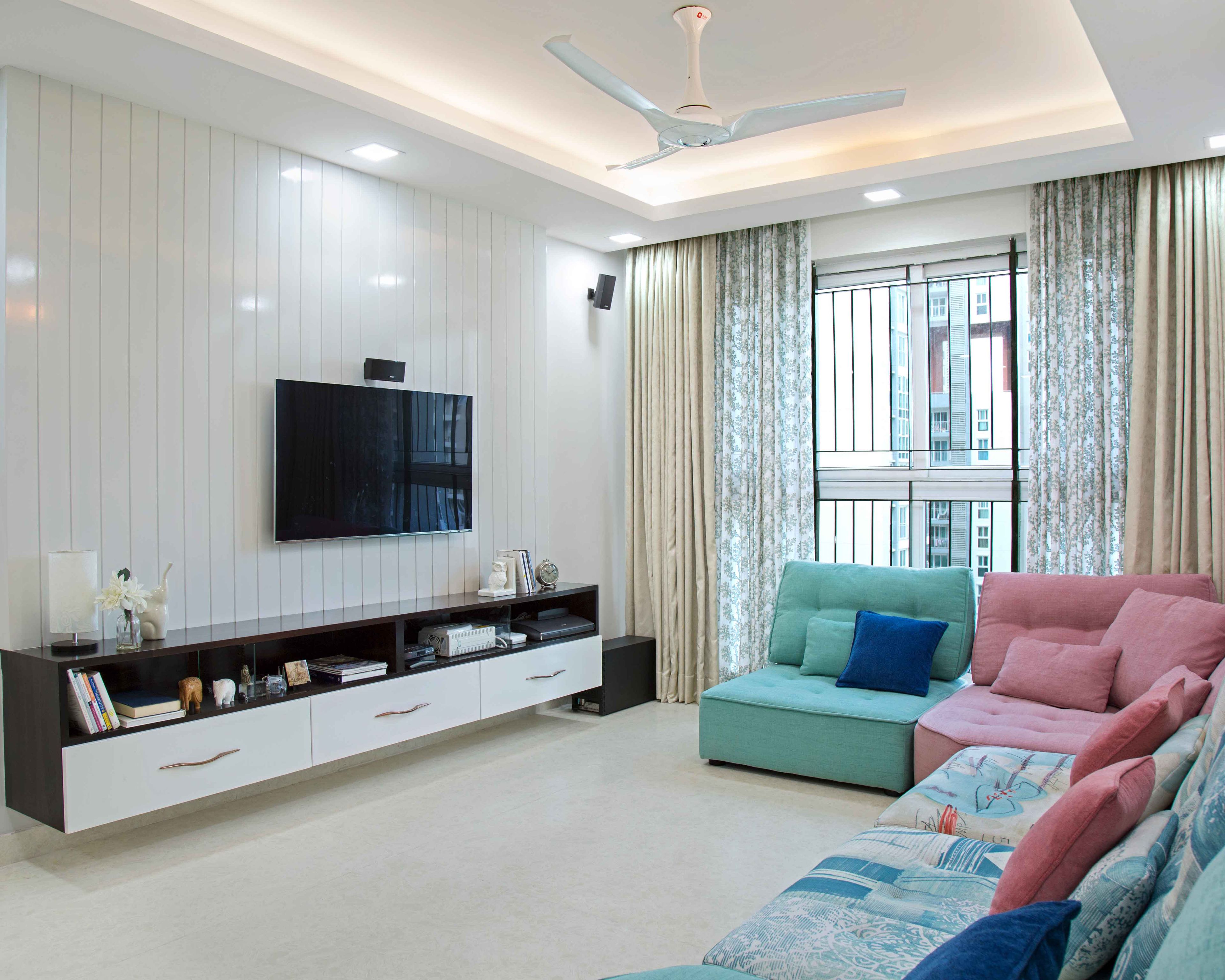 Spacious TV Unit Design With White And Wood Accents With Tall White Wall Panelling - Livspace