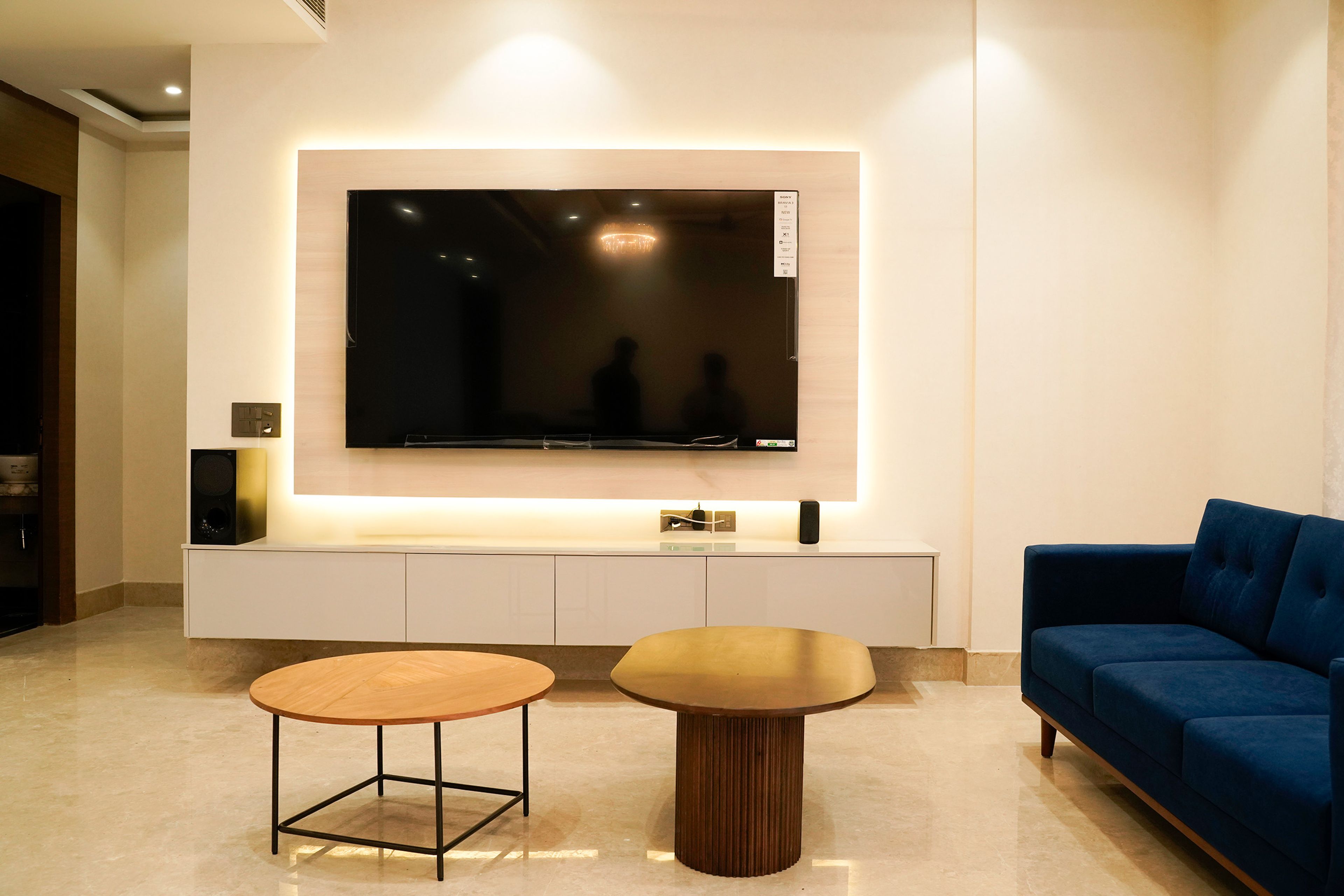 Contemporary Living Room Design with Blue Sectional Sofa and High Back Chairs