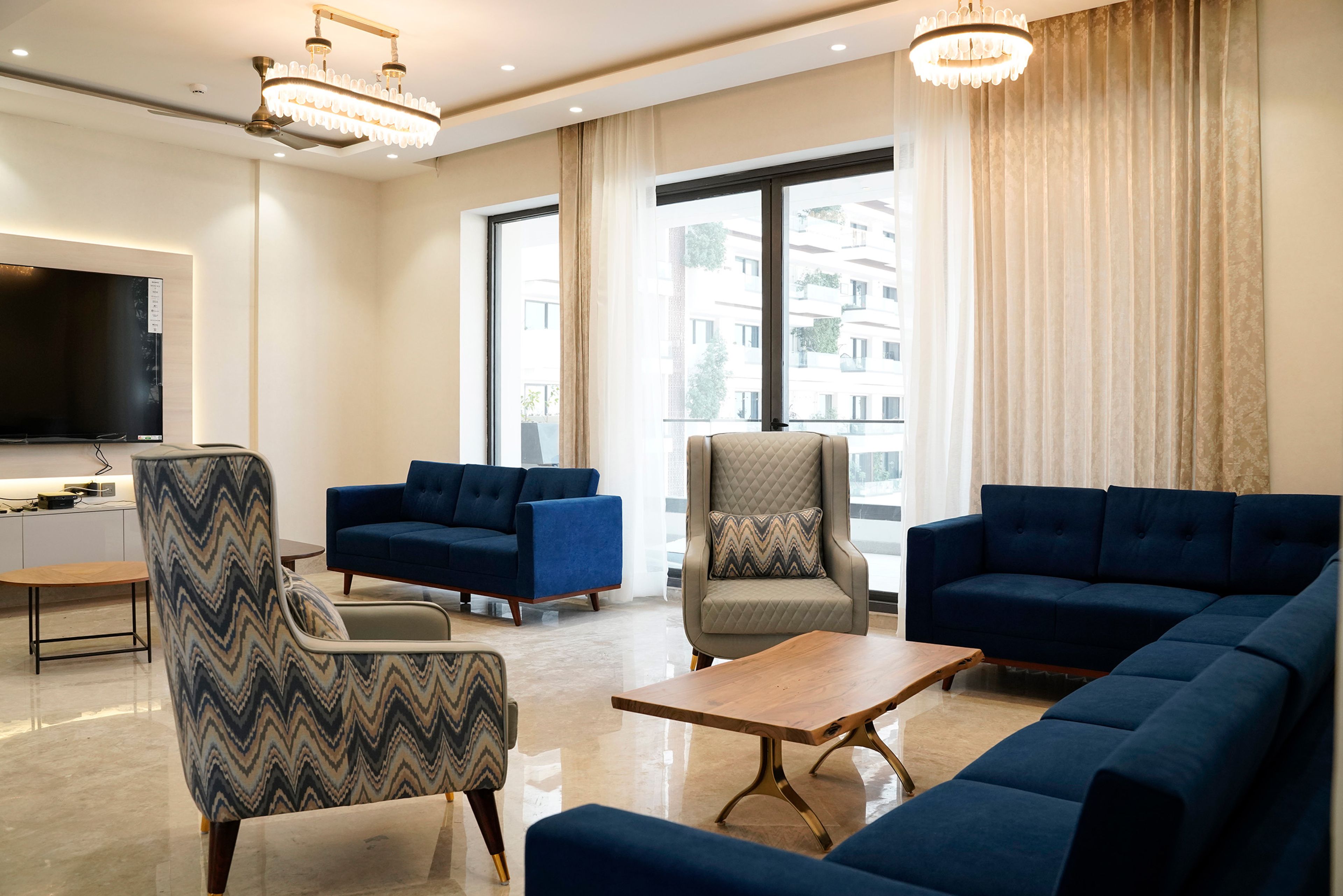 Contemporary Living Room Design with Blue Sectional Sofa and High Back Chairs