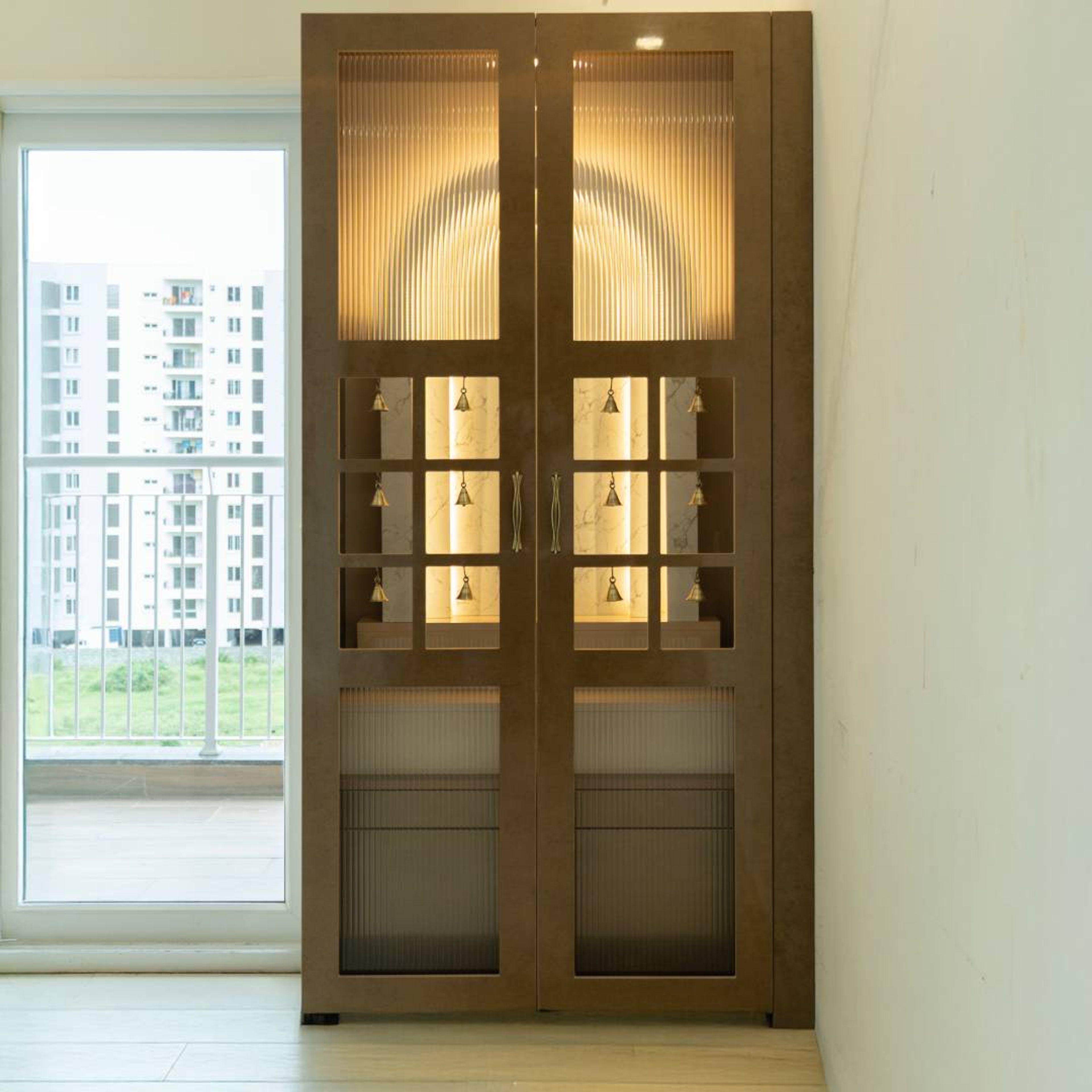 Contemporary Pooja Unit Design in Walnut Oak with Fluted Glass