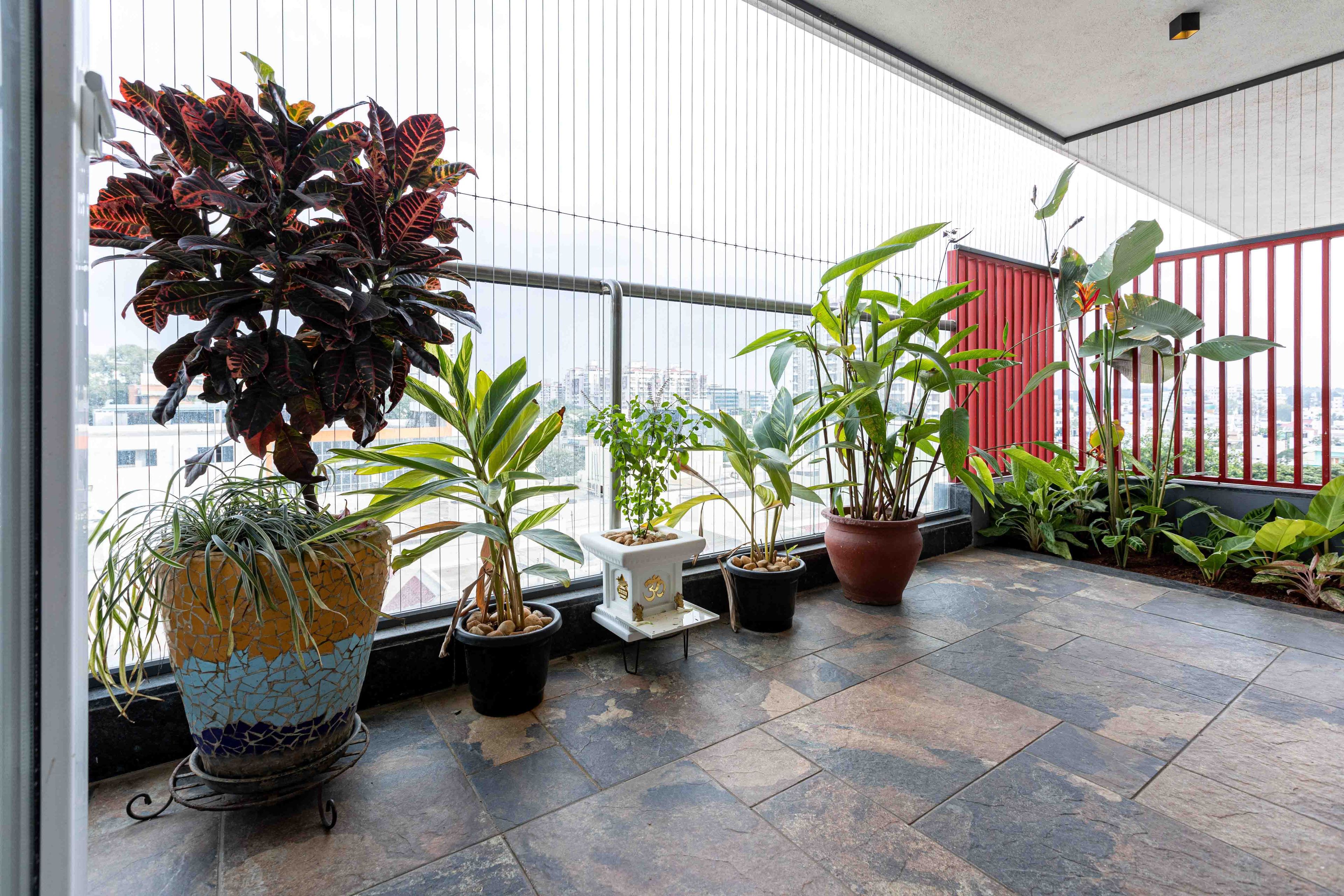 Contemporary Balcony Design with Pink Railings and Stone Flooring
