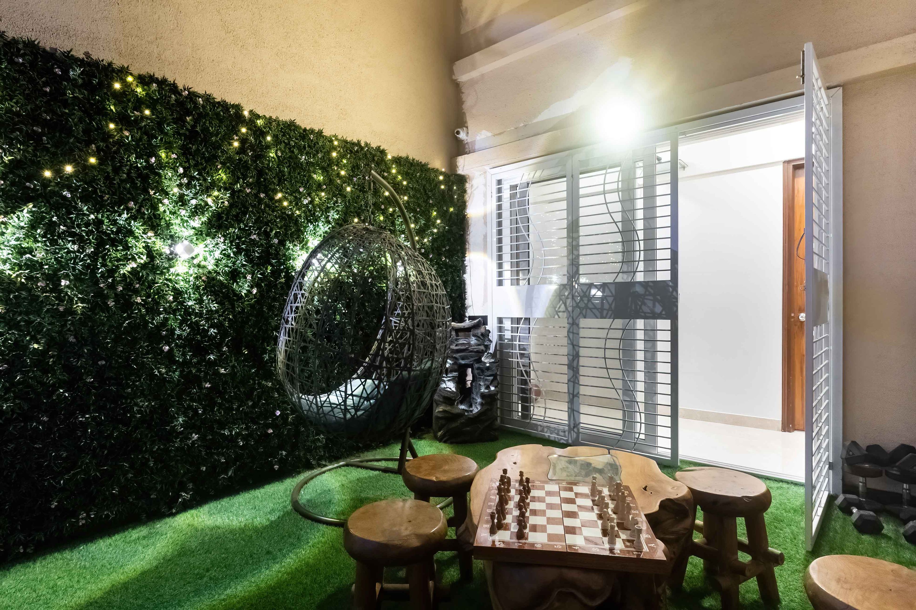 Modern Balcony Design with Green Grass Wall and Cozy Swing