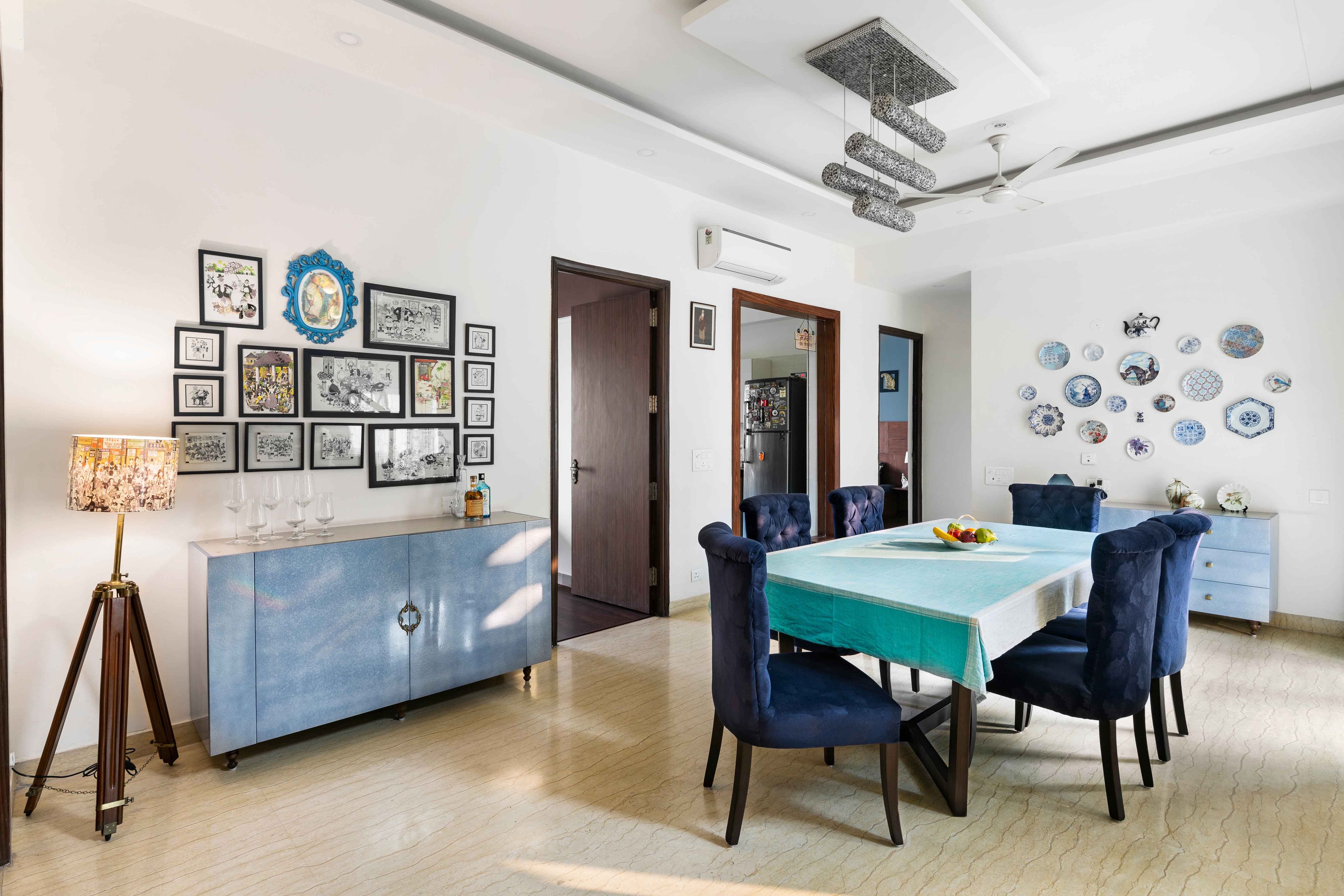 Modern 6-Seater Wooden Dining Room Design With Navy Blue Tufted Chairs