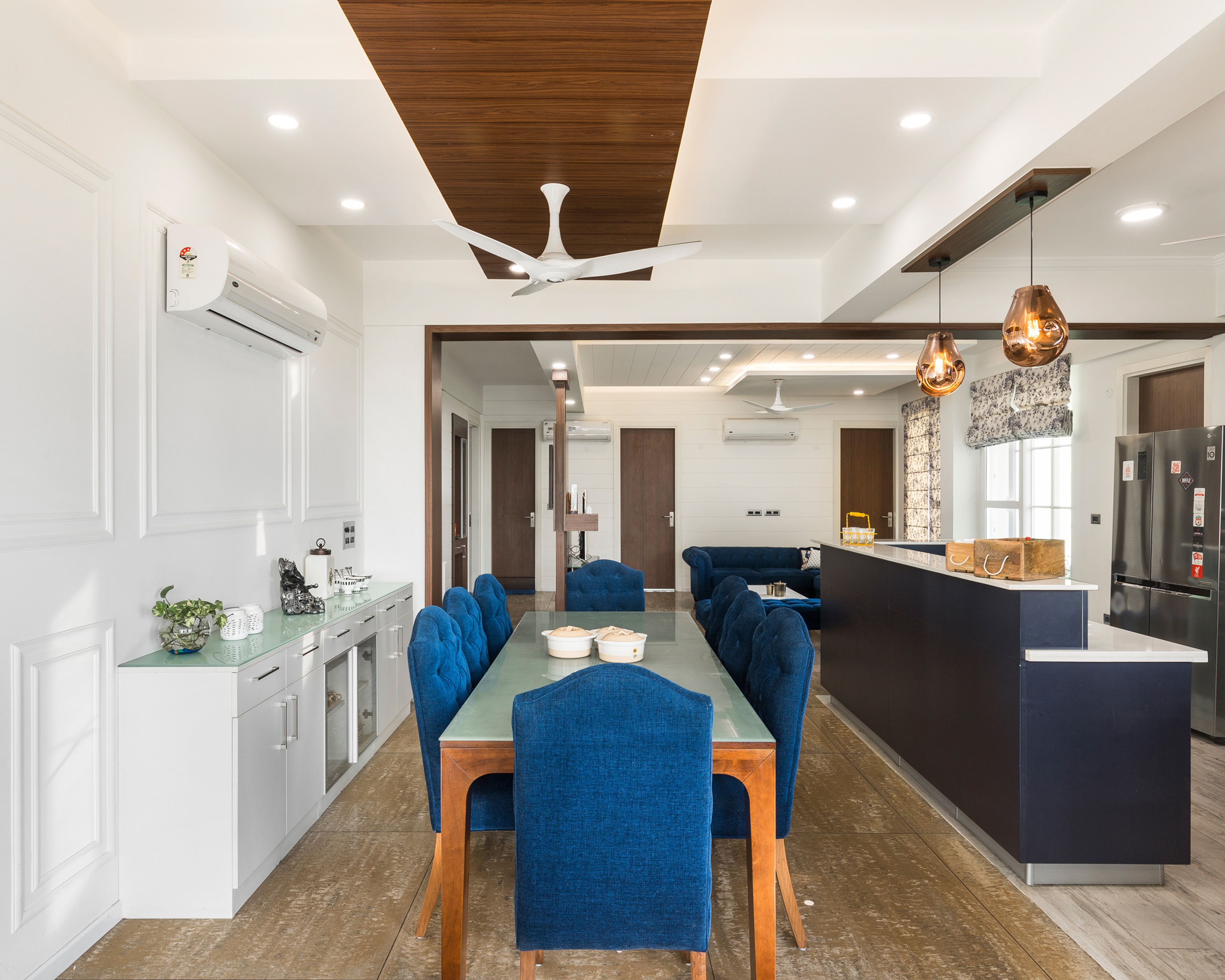 Modern Wooden Dining Room Design With Blue Velvet Upholstered Chairs And White Storage Unit