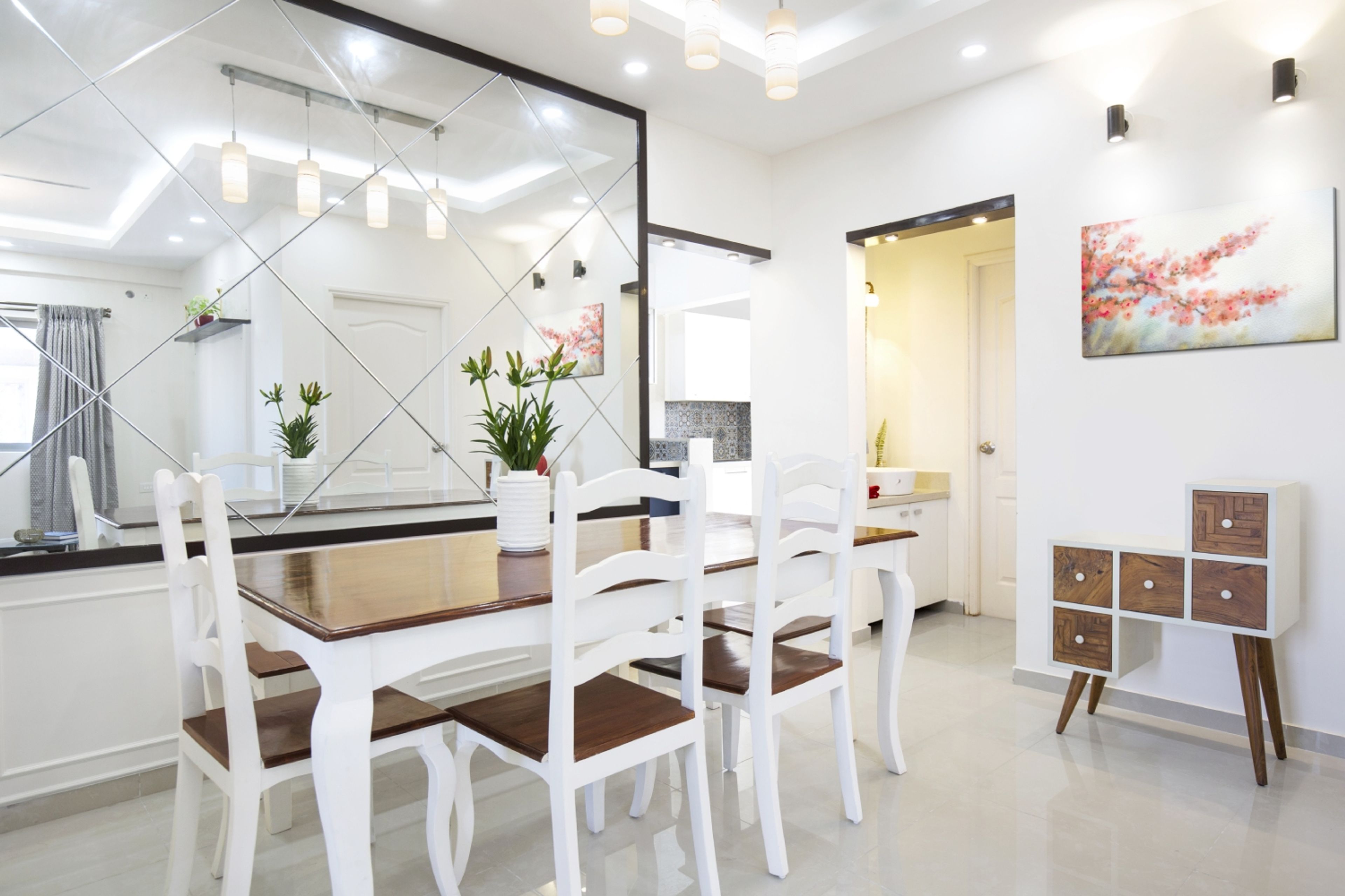 11x10 Ft 4-Seater White And Wood Dining Room Design With Mirrored Wall Panel - Livspace