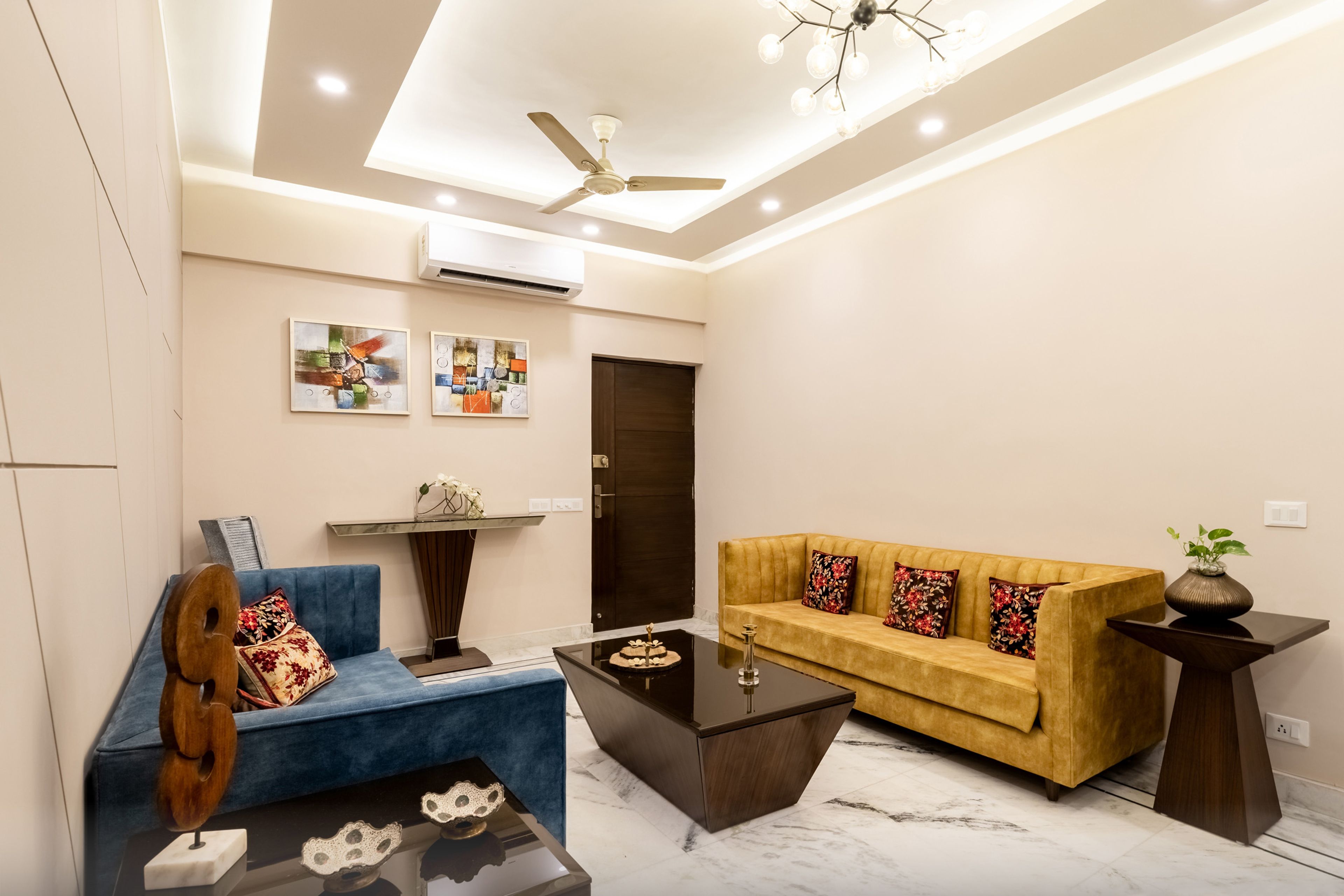 Spacious Living Room Design With Yellow And Blue Upholstery With Rectangular False Ceiling - Livspace