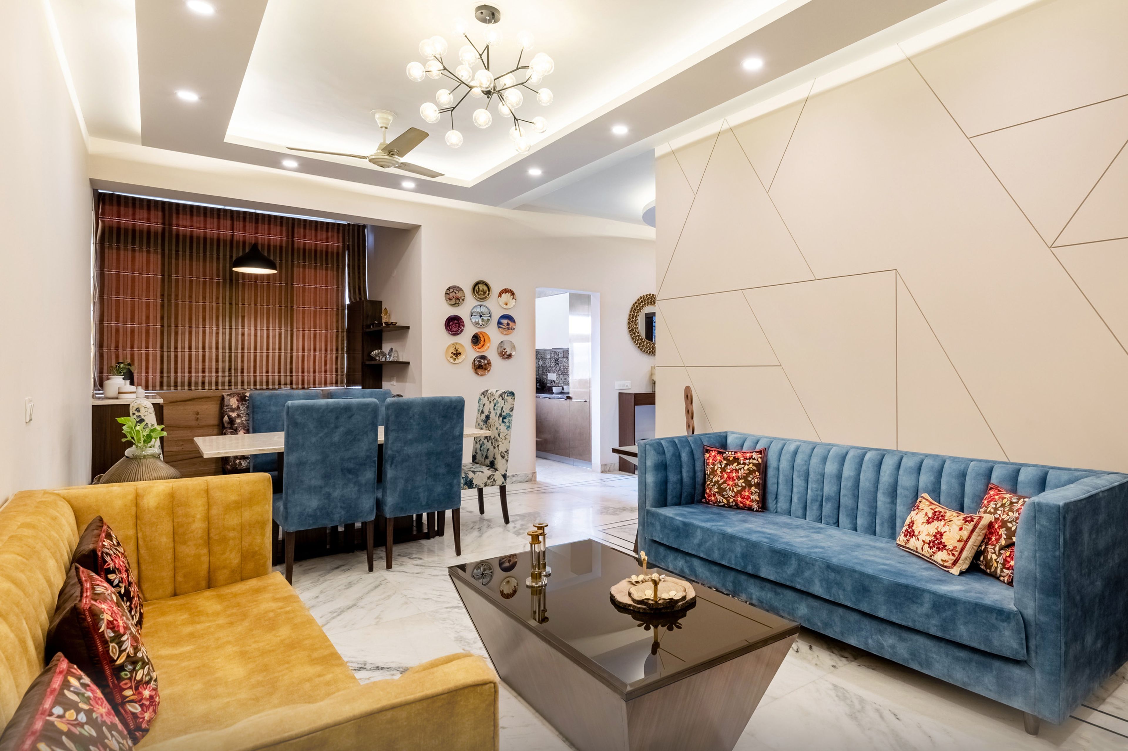 Modern Blue And Yellow Living Room Design With Dining Table - Livspace