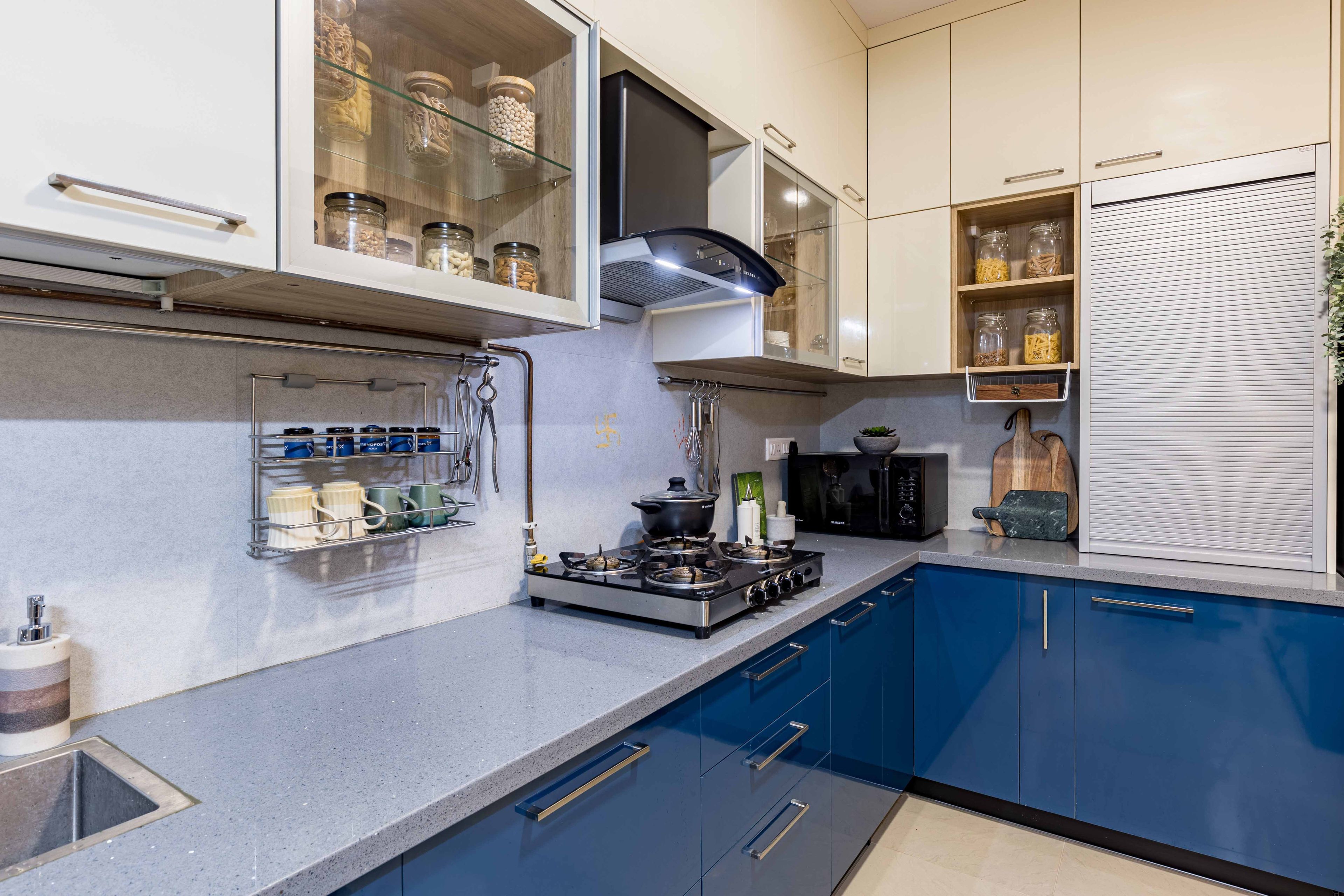 Blue And White Glossy Kitchen Design With Shutter Unit - Livspace