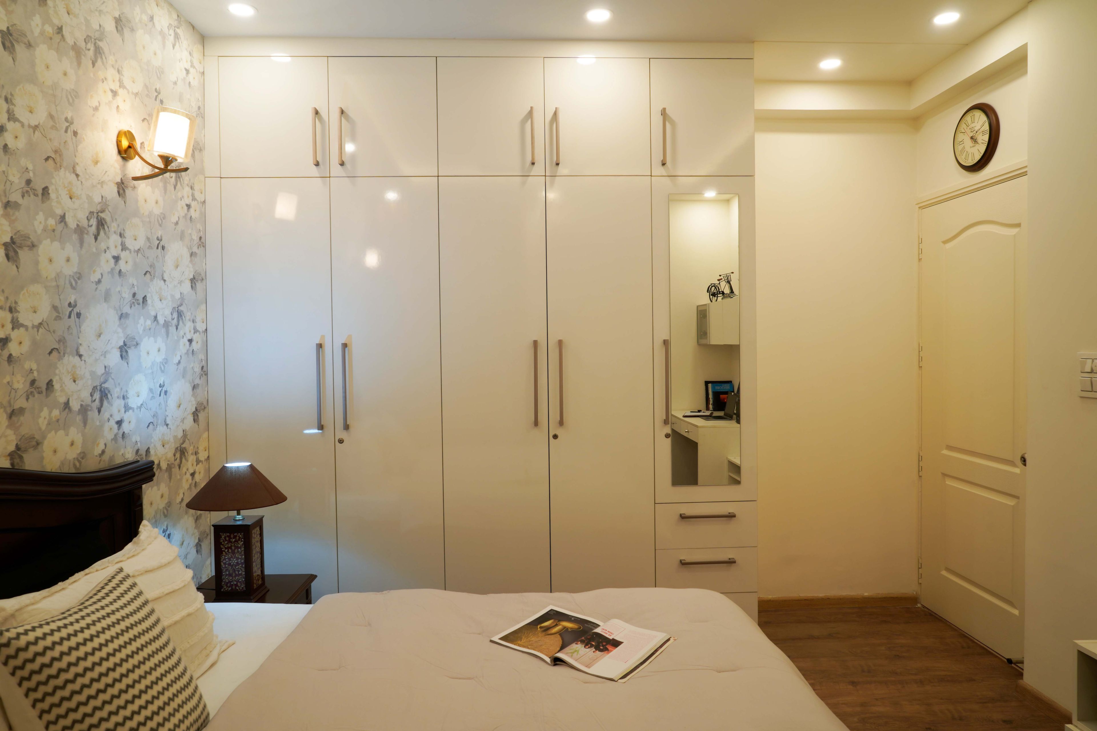 All-White Guest Room Design With White Mirrored Wardrobe - Livspace