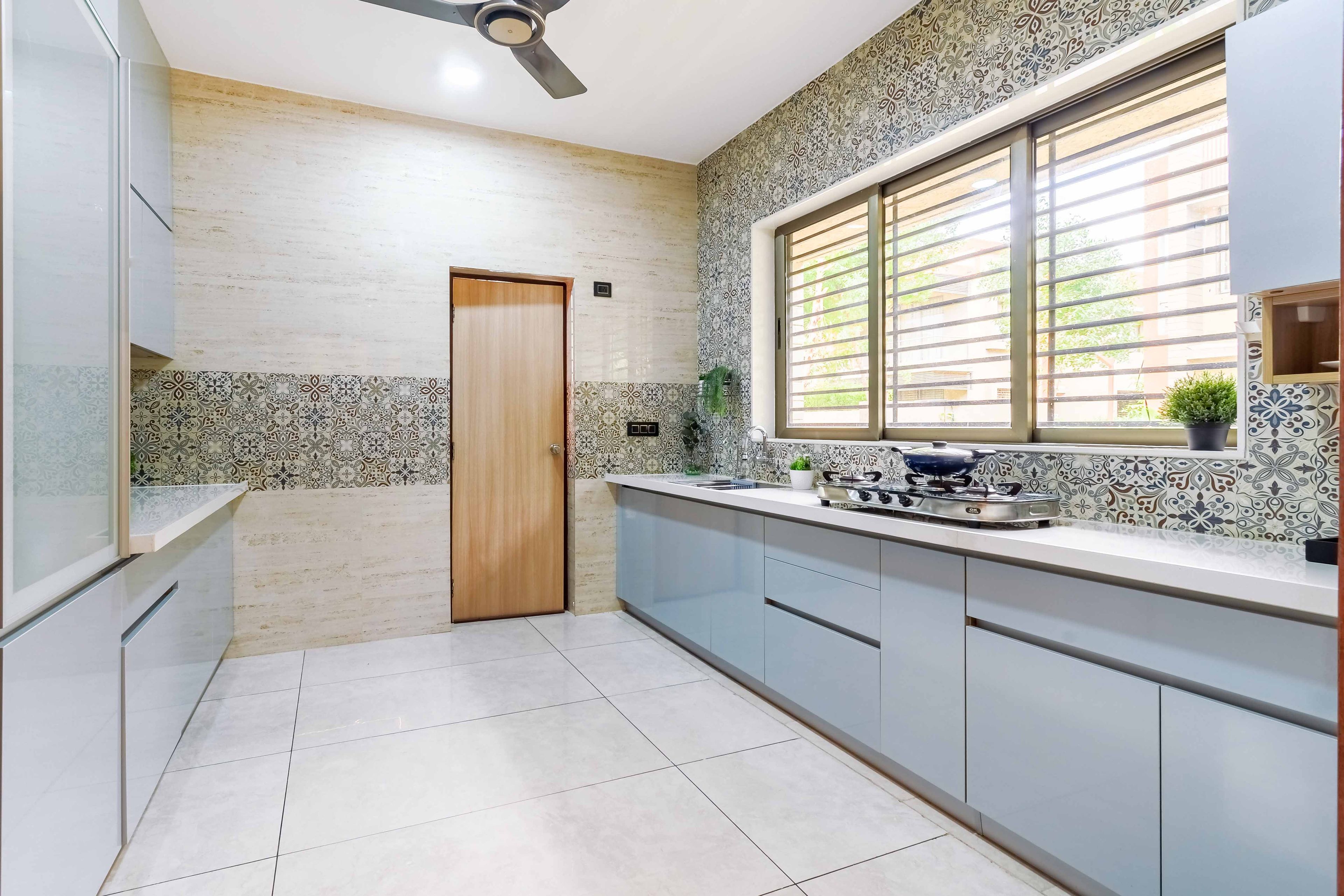 Contemporary 3-BHK Flat In Ahmedabad With Spacious Light Blue Kitchen Design