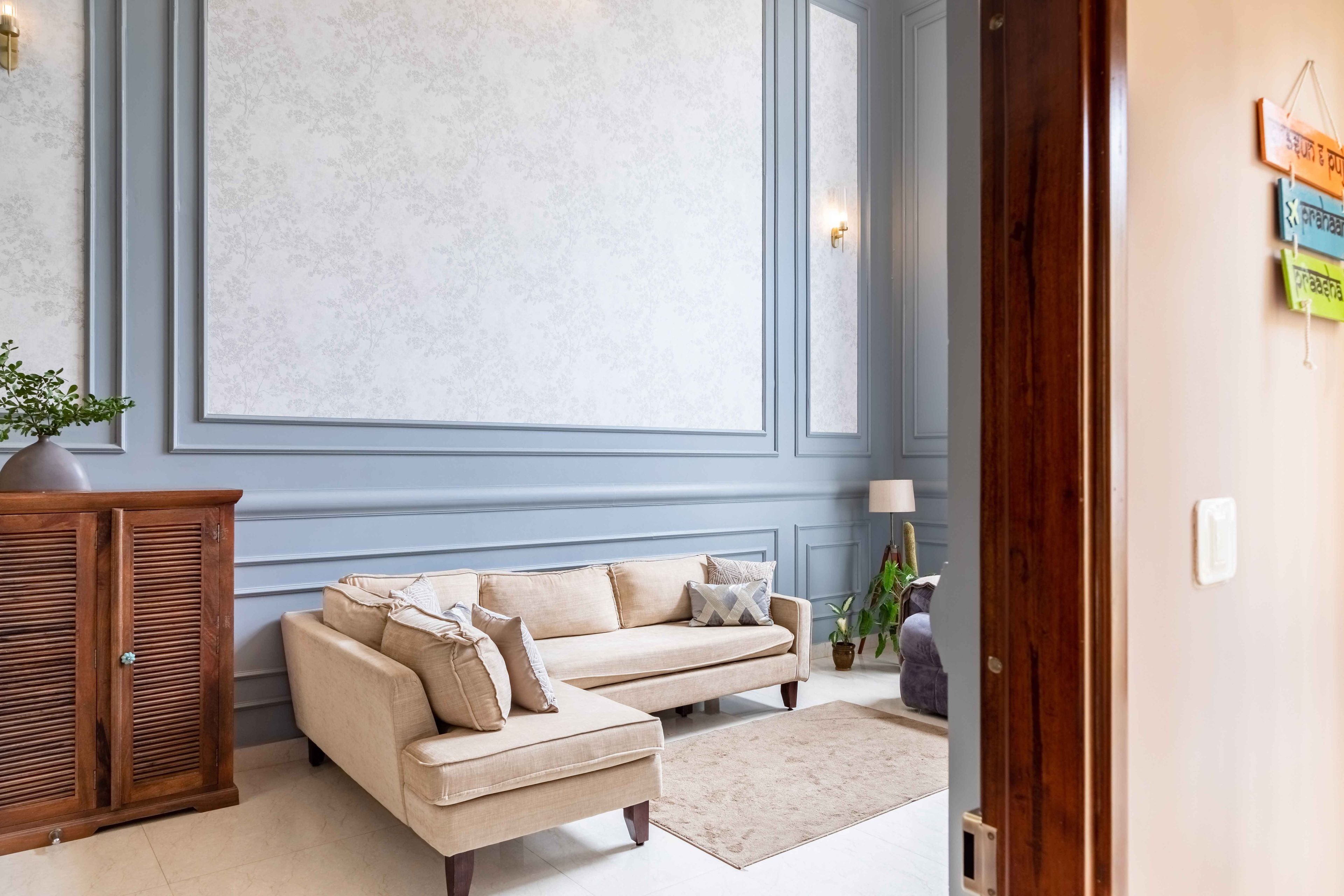 Spacious Living Room Design With Blue Accent Wall And Off-White Seater- Livspace