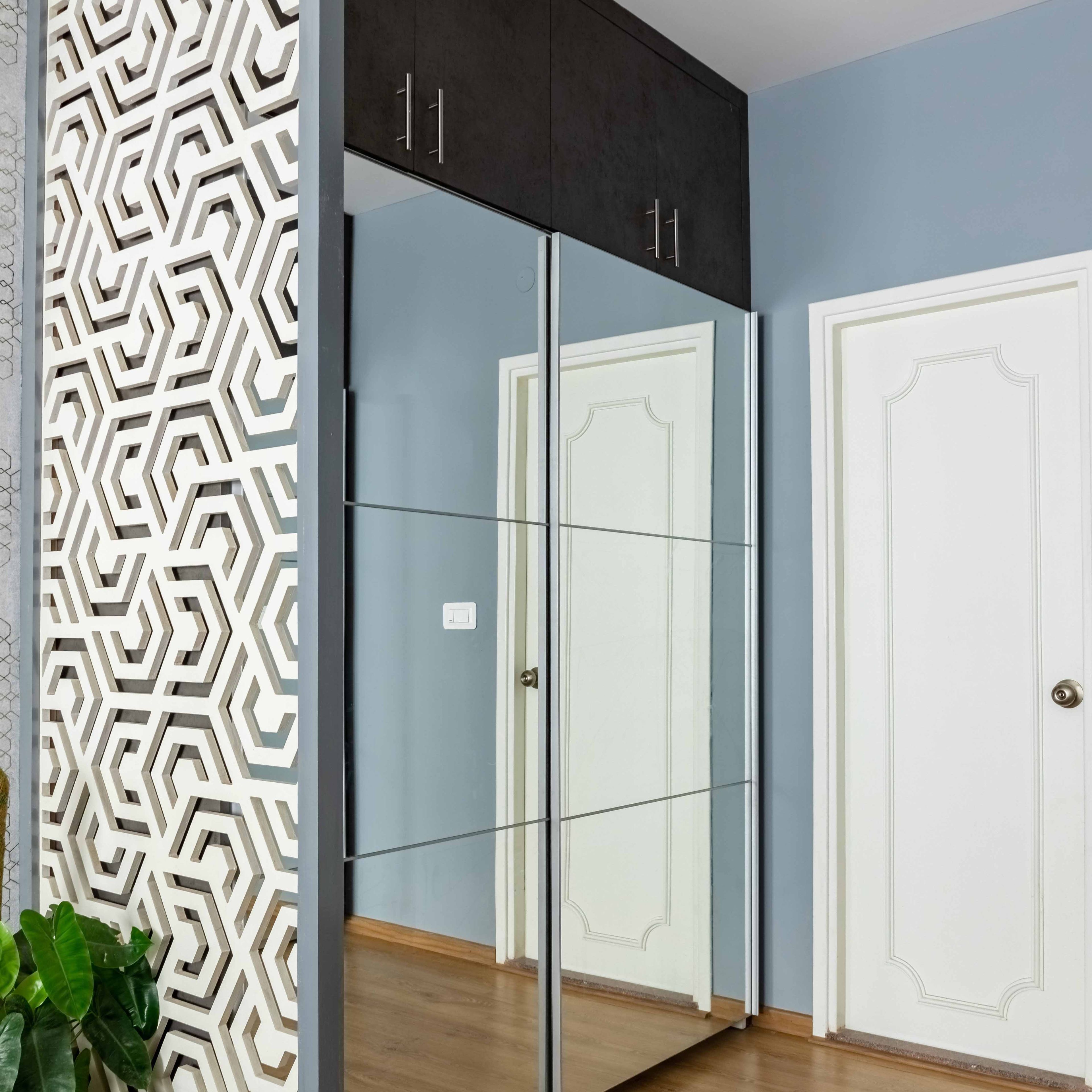 Mirrored Sliding Wardrobe Design With Side Jali Pattern - Livspace