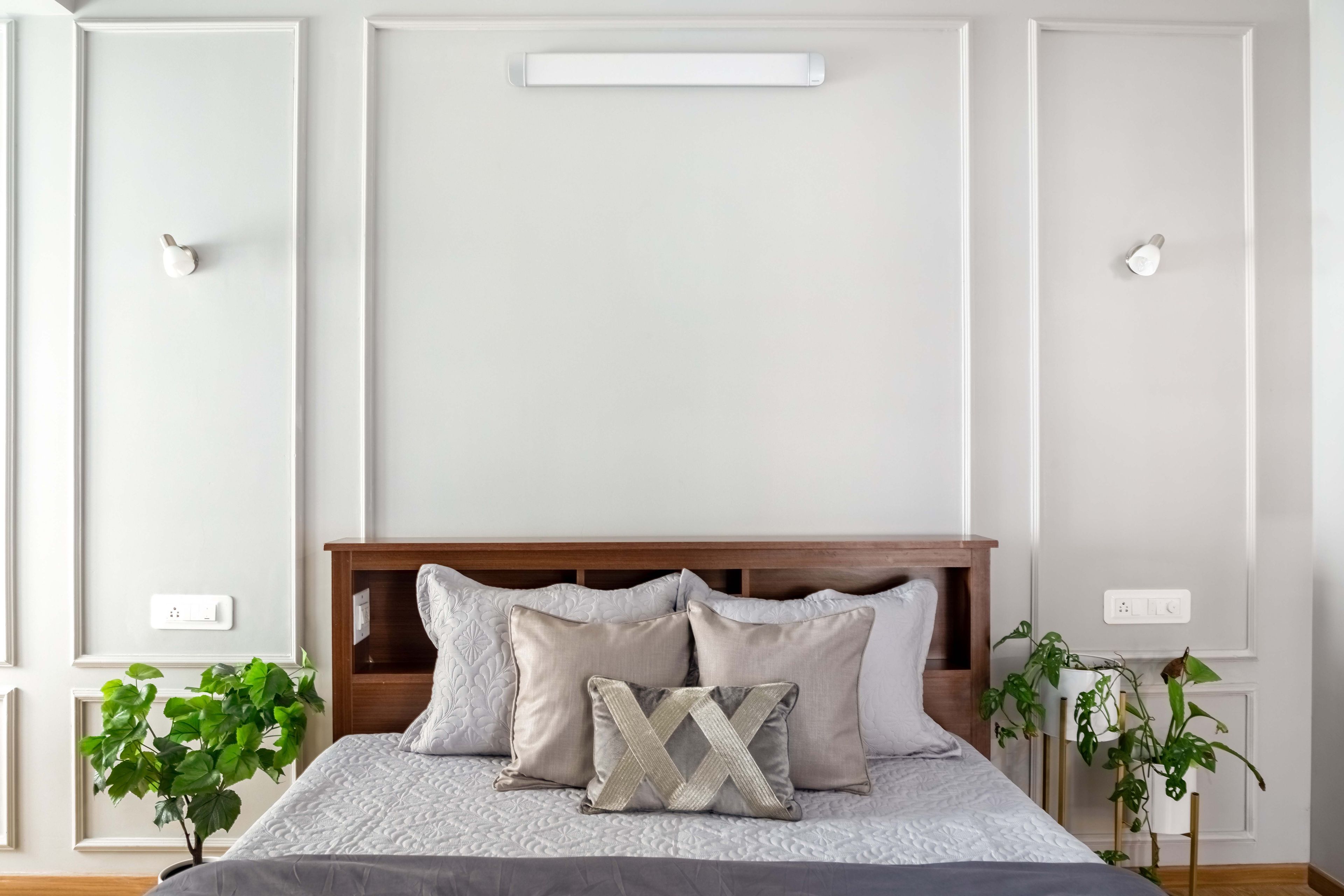 White Guest Room Design With Wall Trims And Wooden Bed - Livspace