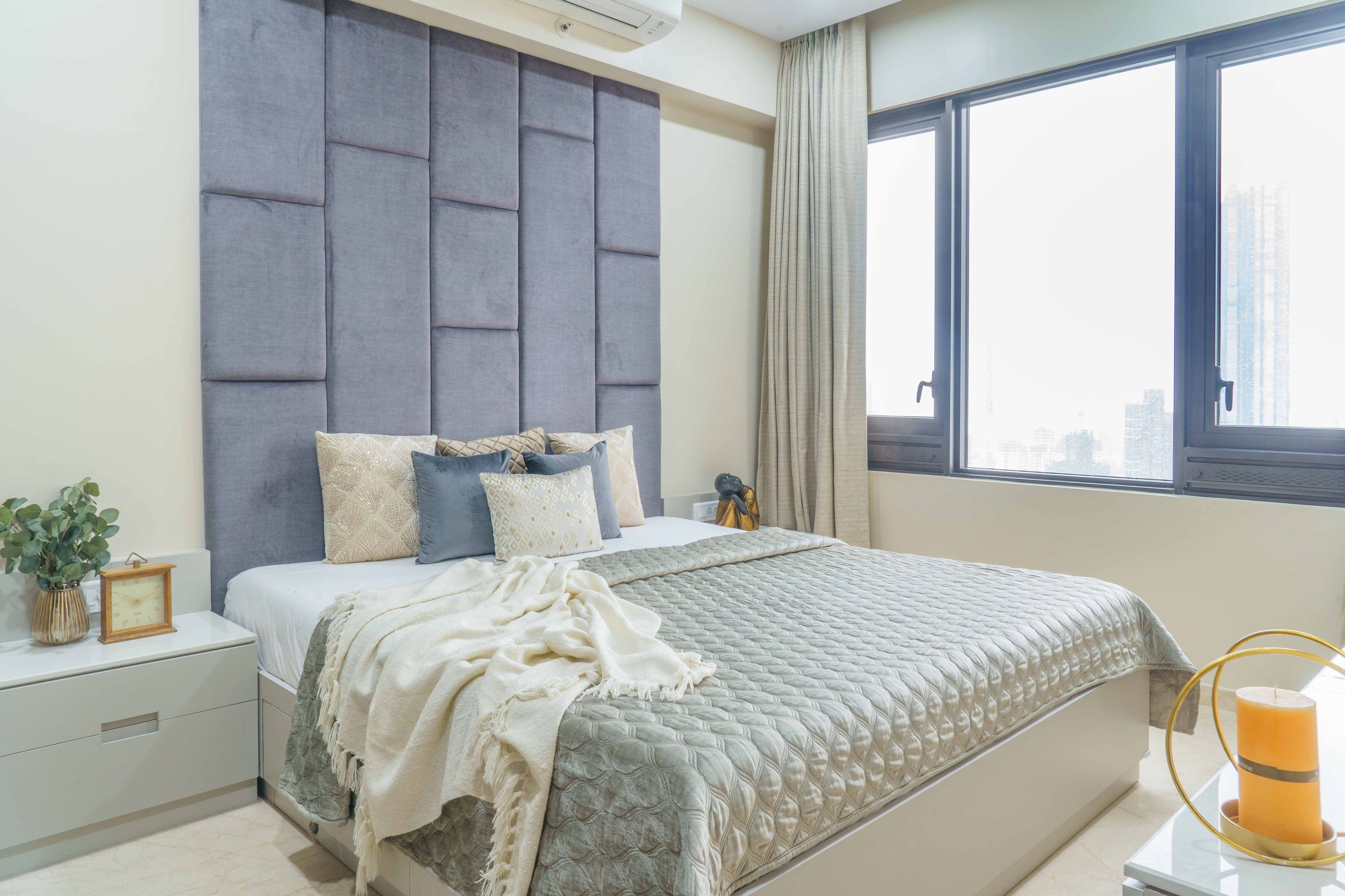 Grey And White Master Bedroom Design With Tufted Accent Wall - Livspace