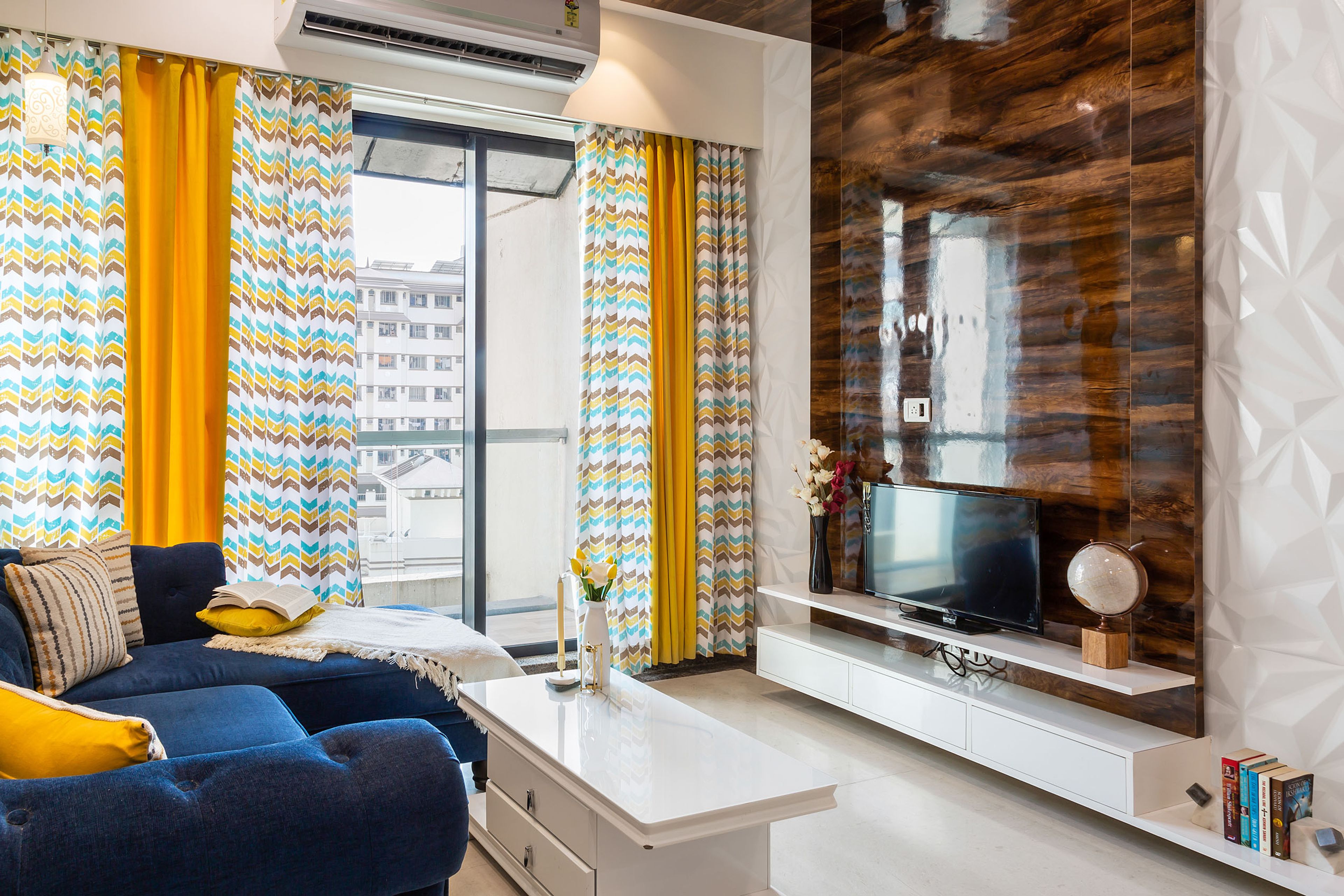 Modern 3-BHK Flat In Mumbai With Glossy Wooden TV Unit Design