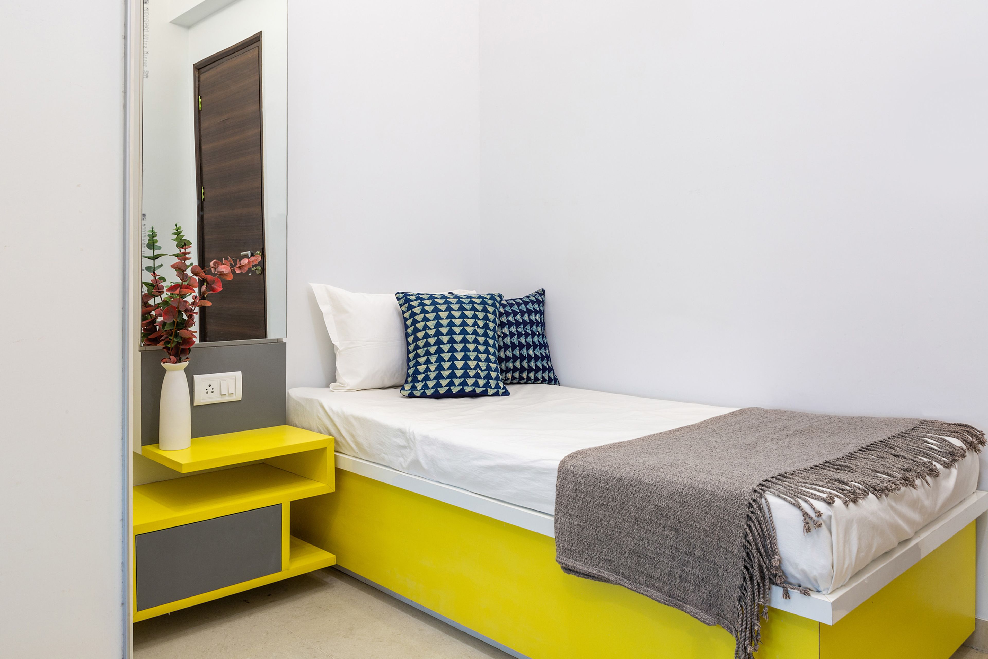 Kids Bedroom With Single Yellow Bed And Dressing Unit - Livspace
