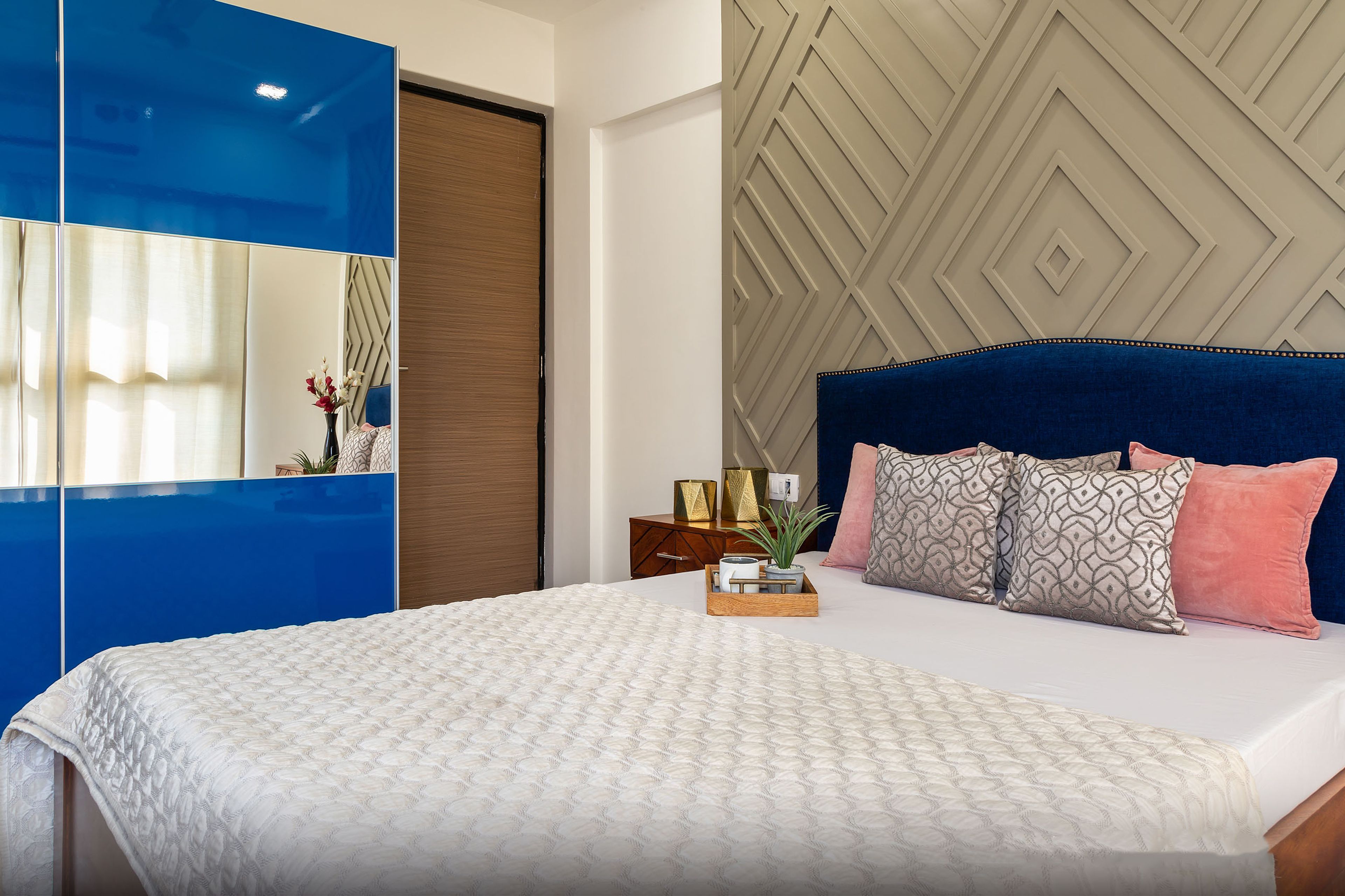 Master Bedroom With Cappucino-Toned Accent Wall With Trims And Blue Mirrored Sliding Wardrobe - Livspace