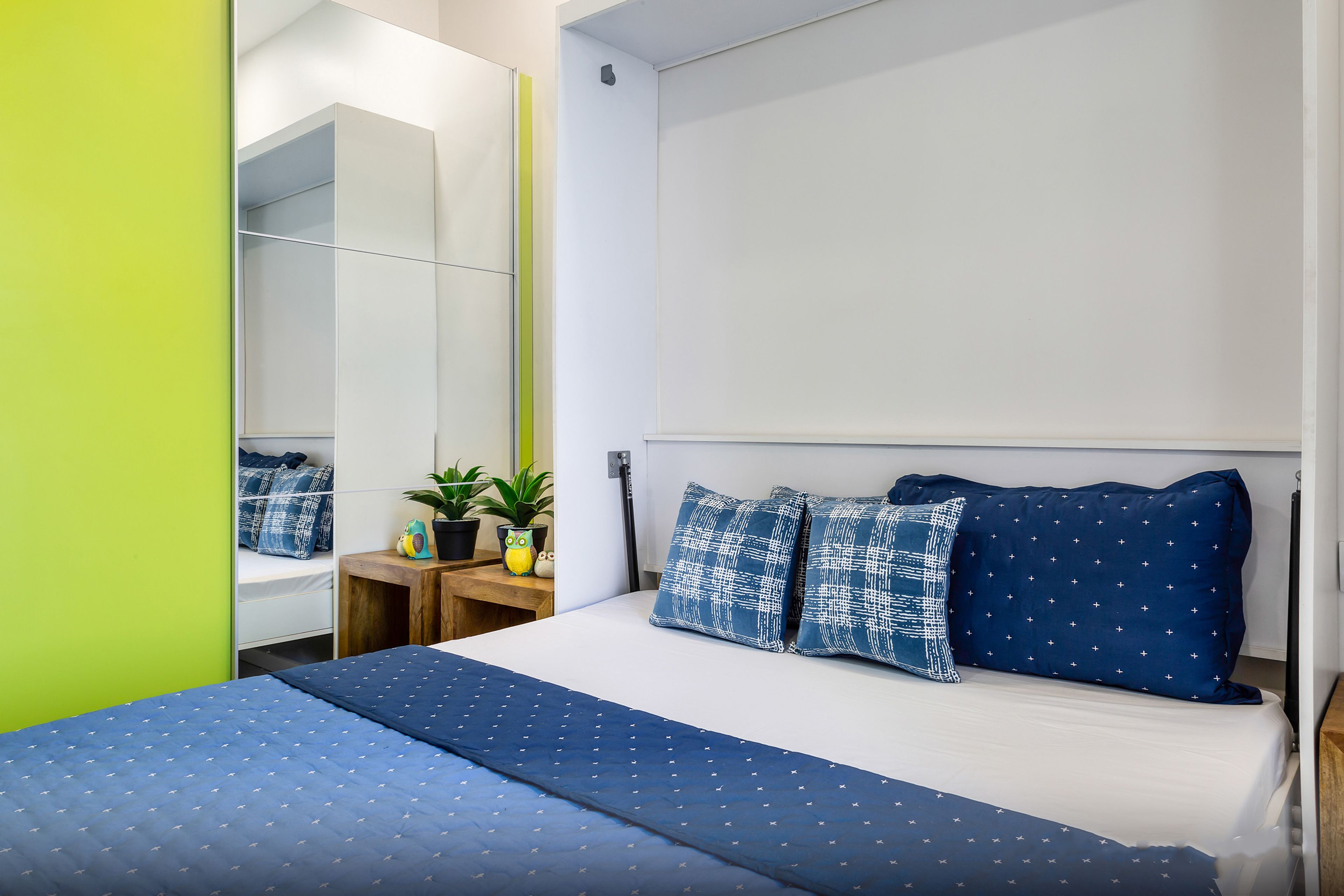 Guest Room with Neon Green Sliding Wardrobe Design And Blue Bed - Livspace