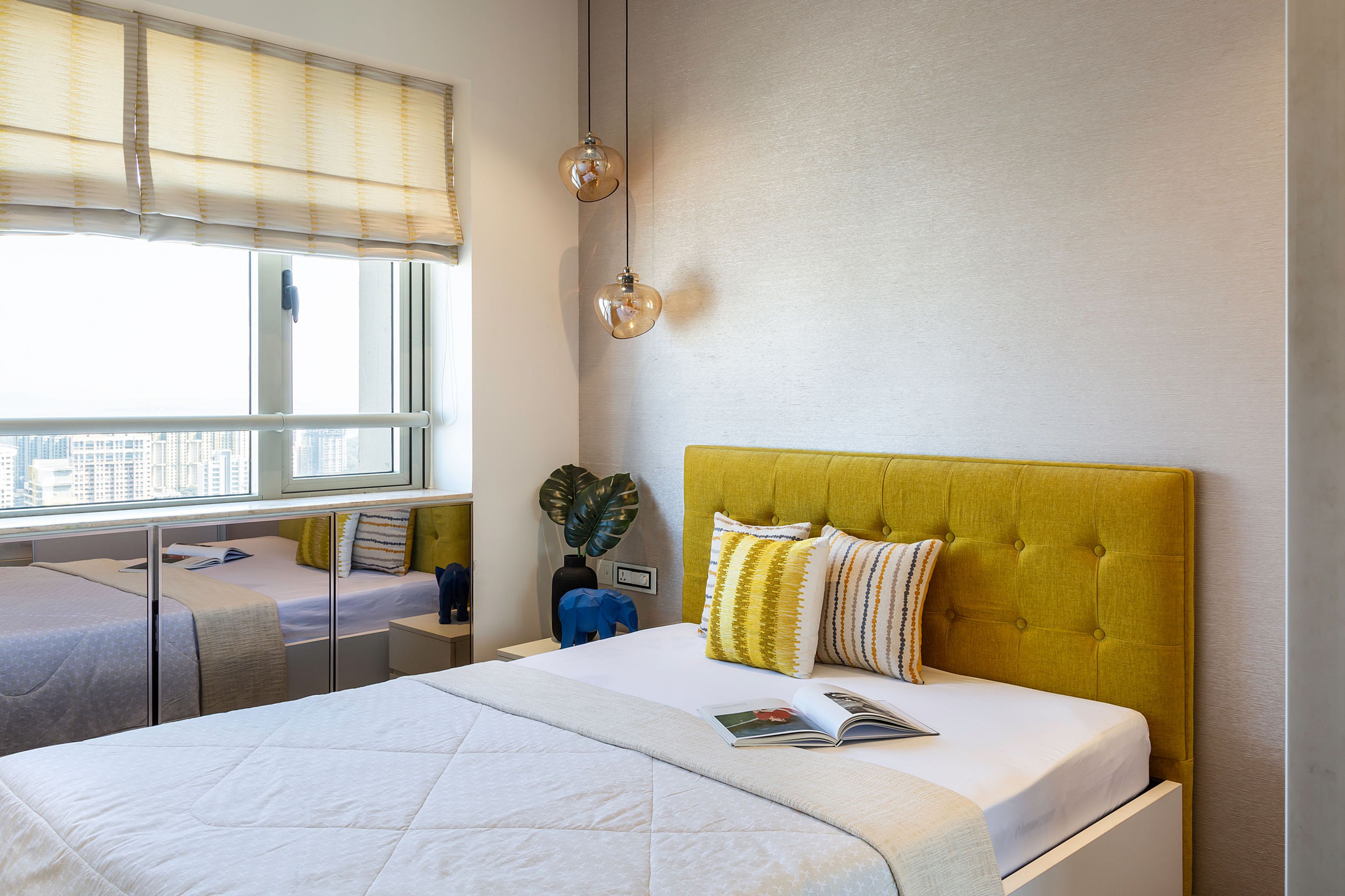 Guest Room Design With Yellow Headboard And Floor Mirrored Storage Units - Livspace