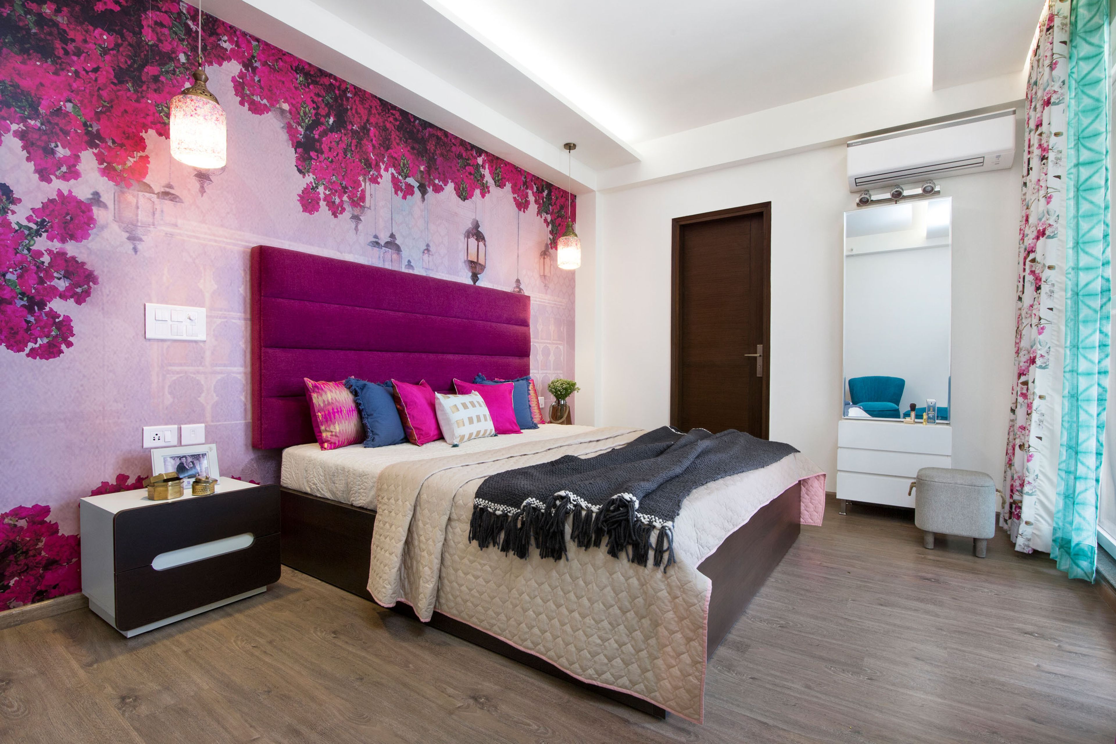 Master Bedroom Design With Purple Tufted Headboard And Floral Wallpaper - Livspace