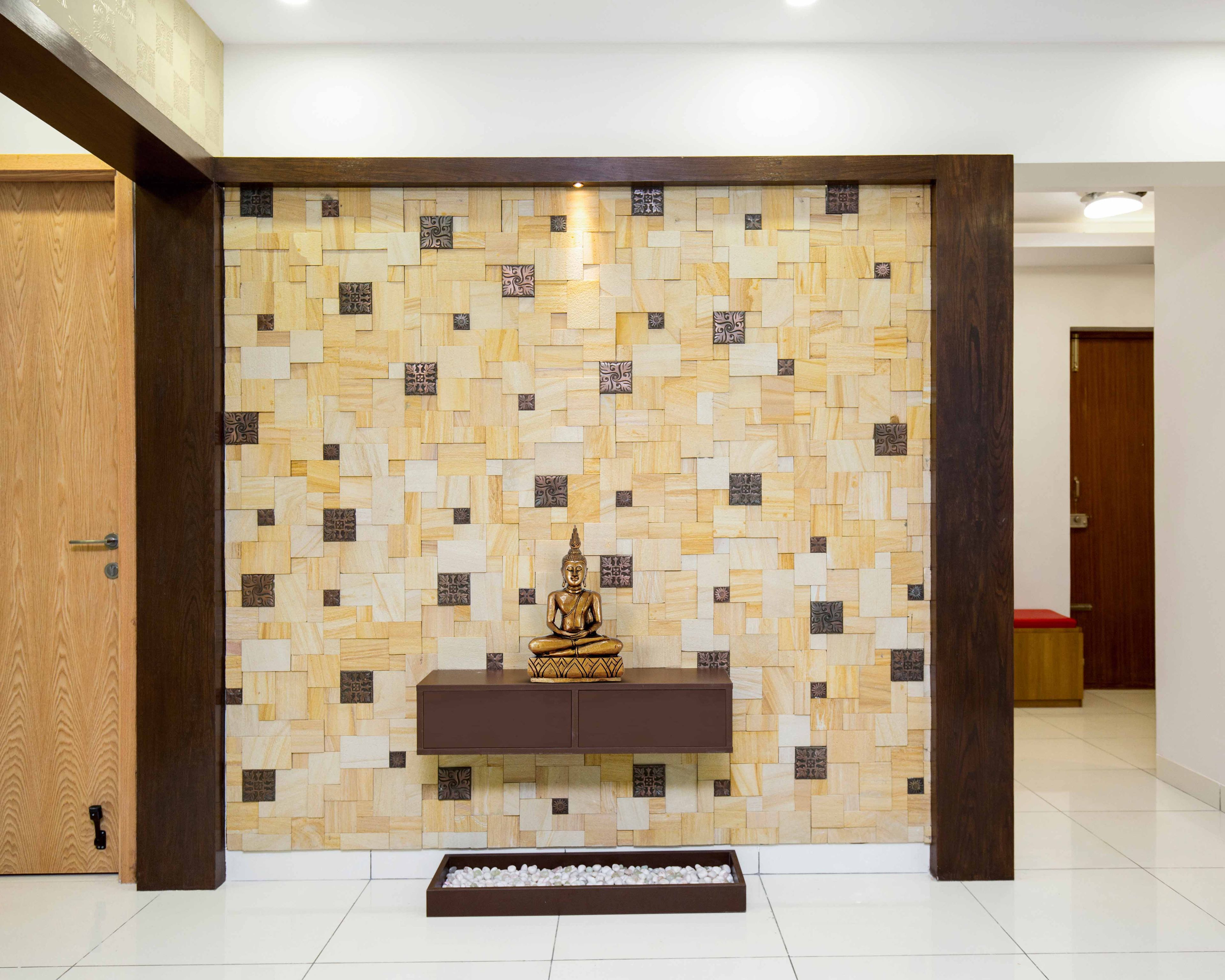 Beige foyer design with Buddha statue and wooden floating console - Livspace