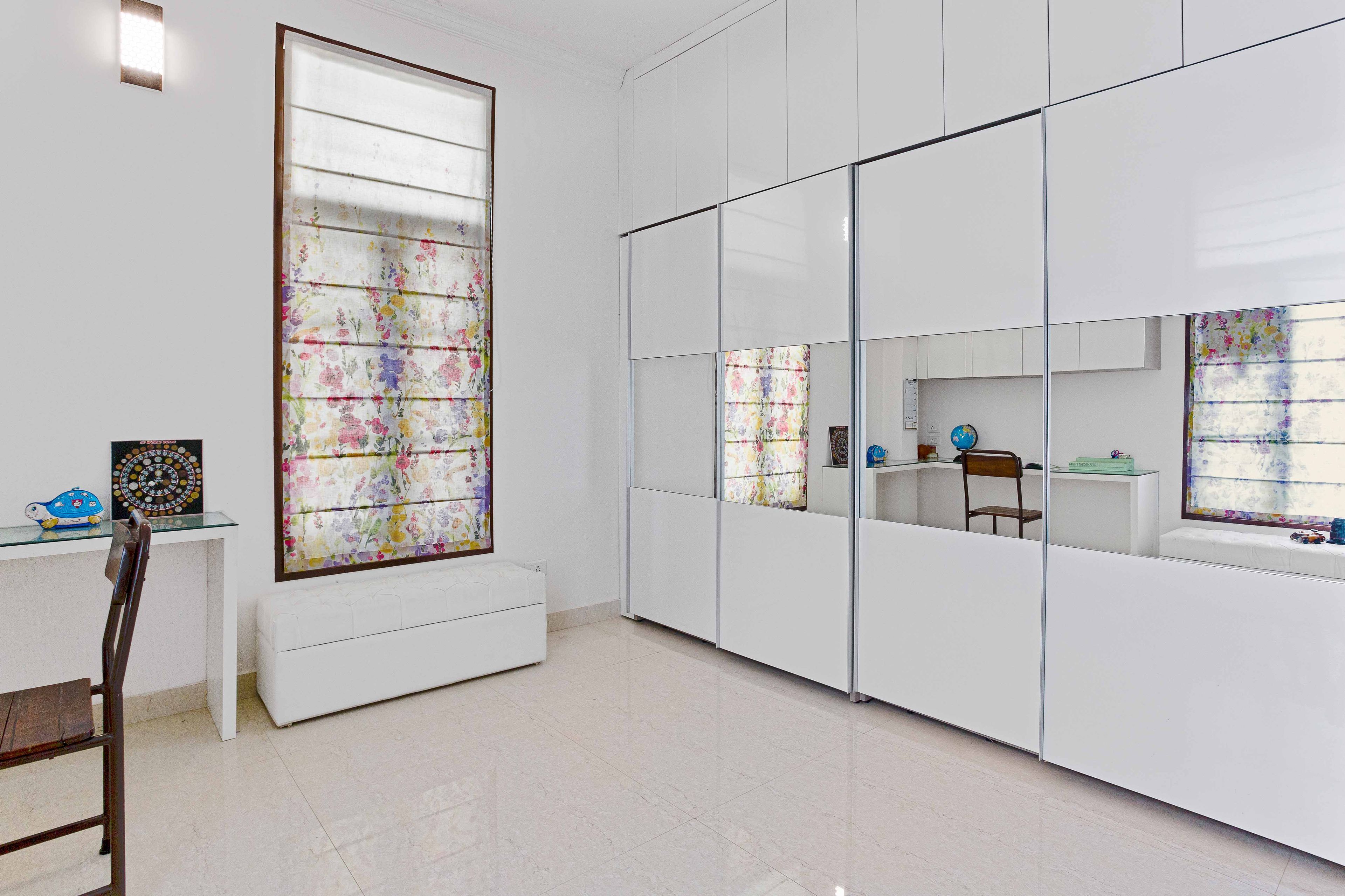 White Home Office Design With Spacious Sliding Mirrored Wardrobe Design - Livspace