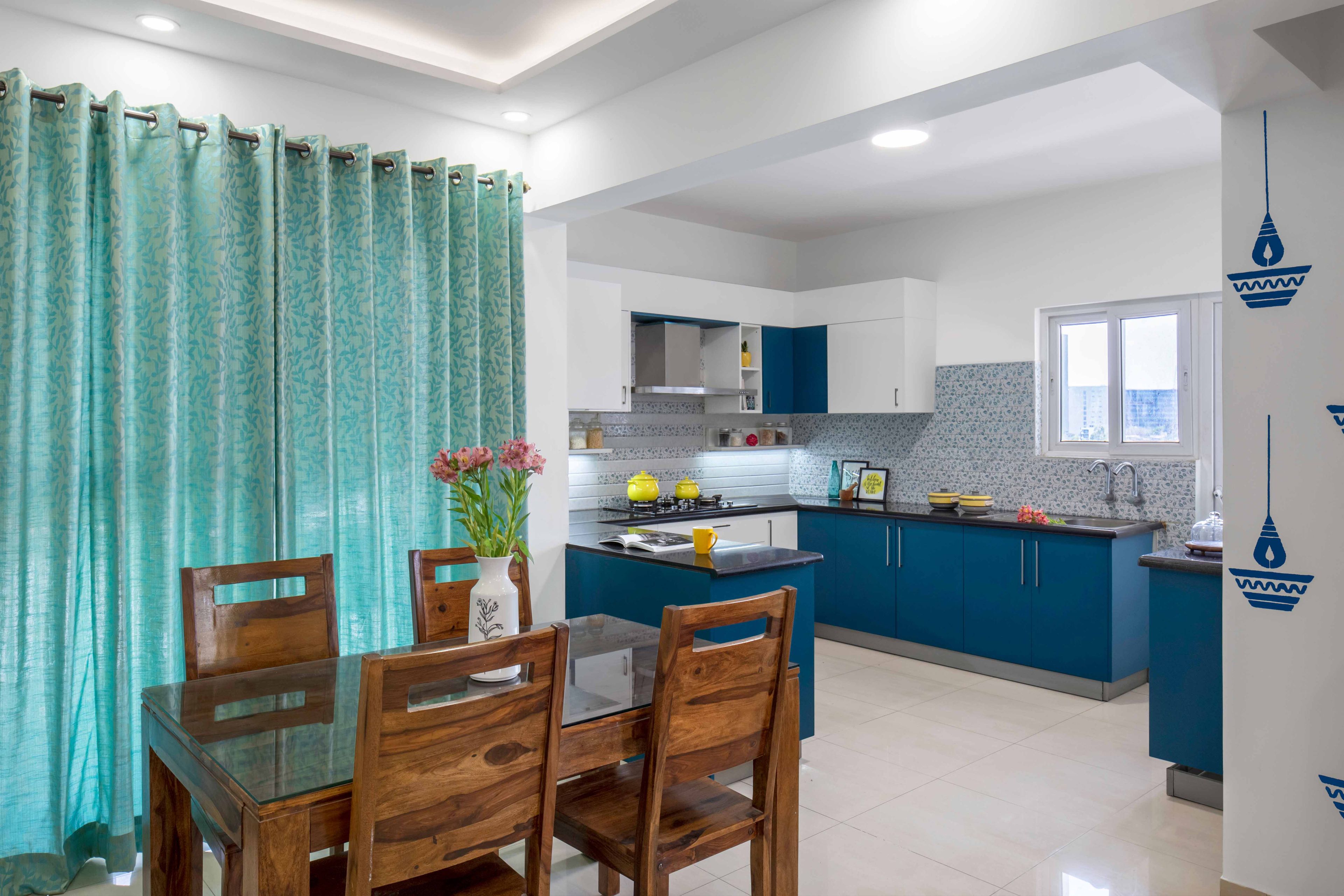 Open kitchen design with 4-seater wooden dining room - Livspace