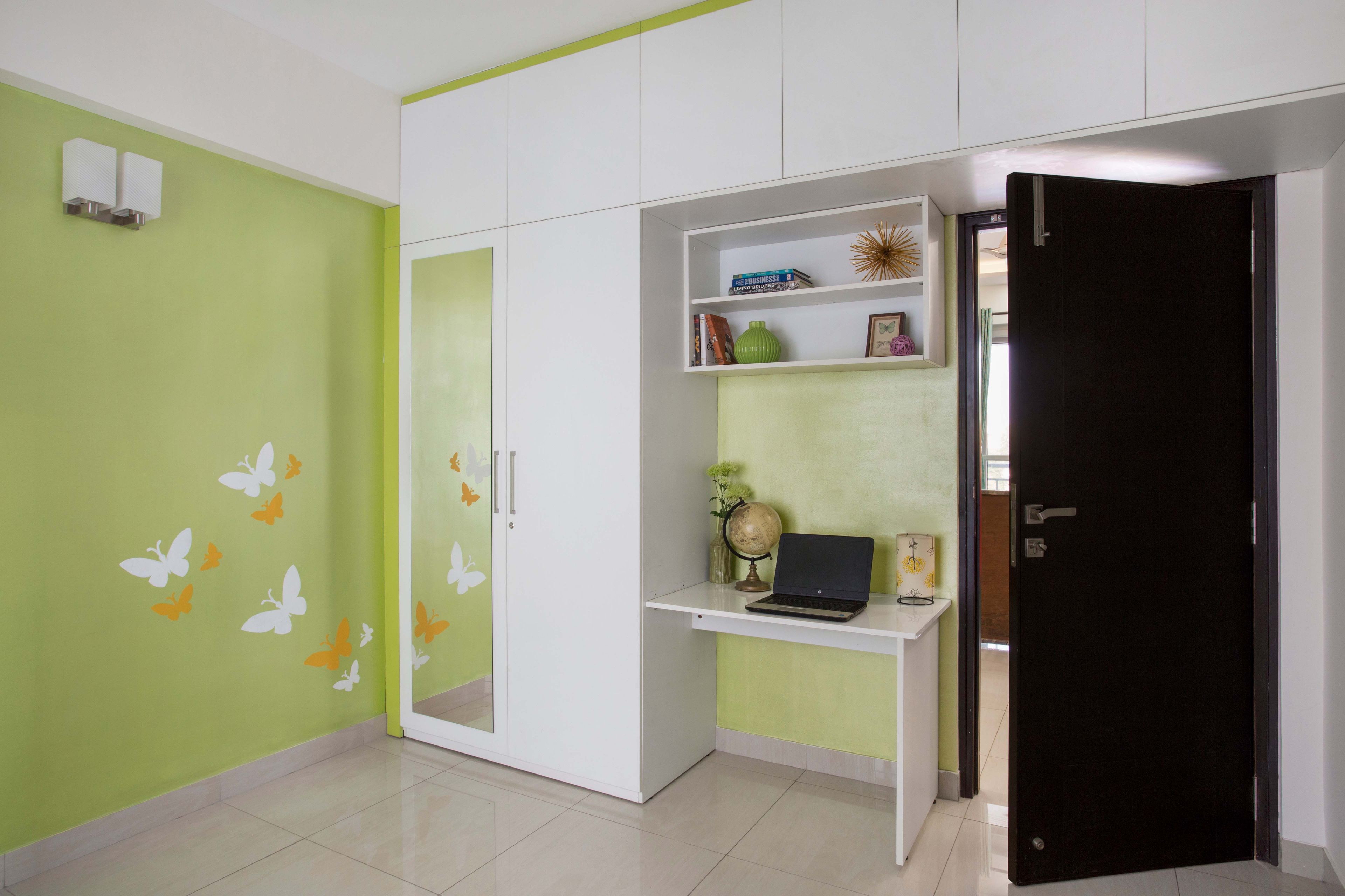 Green and white kid's bedroom design with 2-door swing wardrobe, lofts and a study table - Livspace