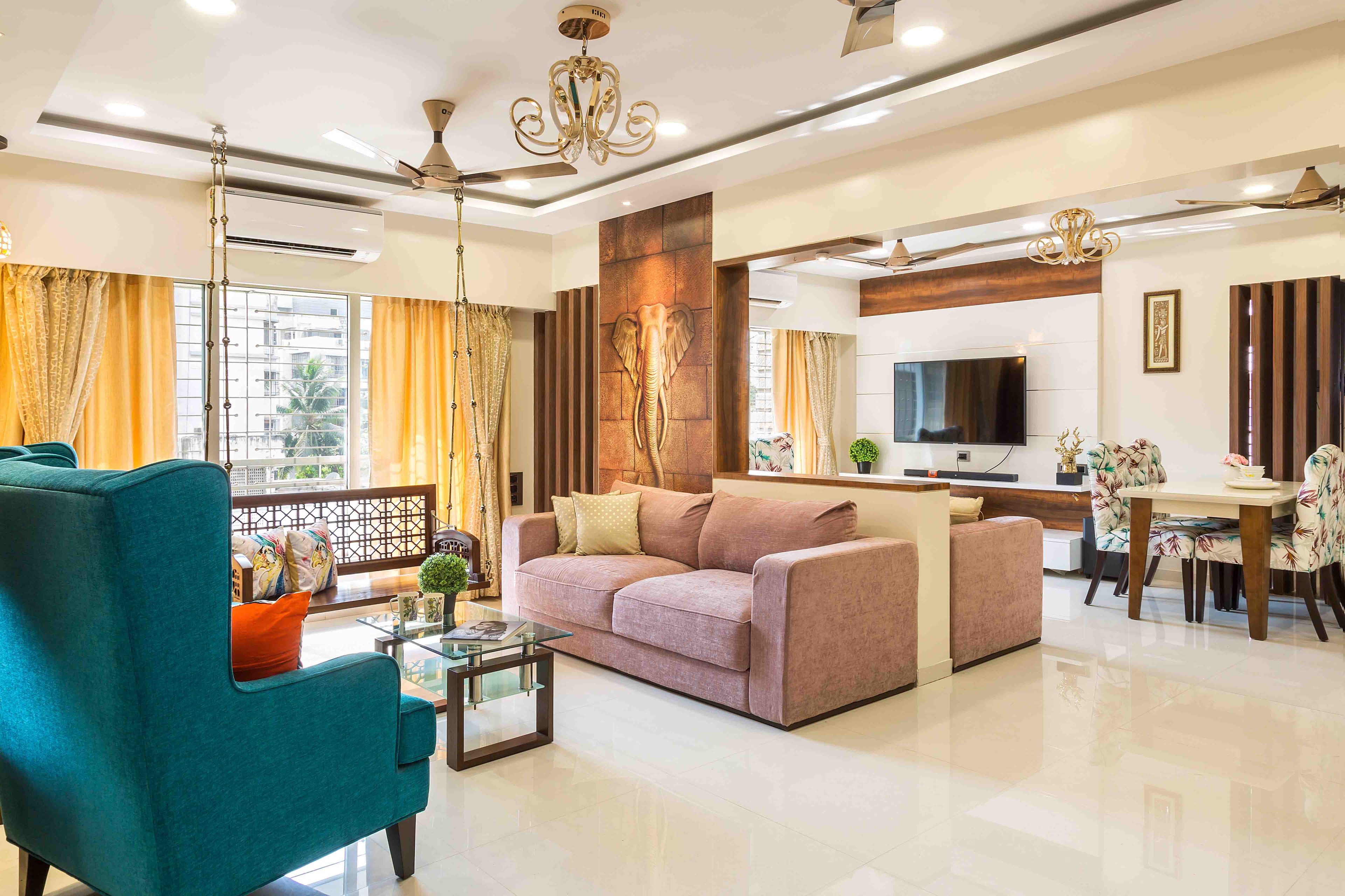 Spacious light pink and turquoise living room design with swing - Livspace