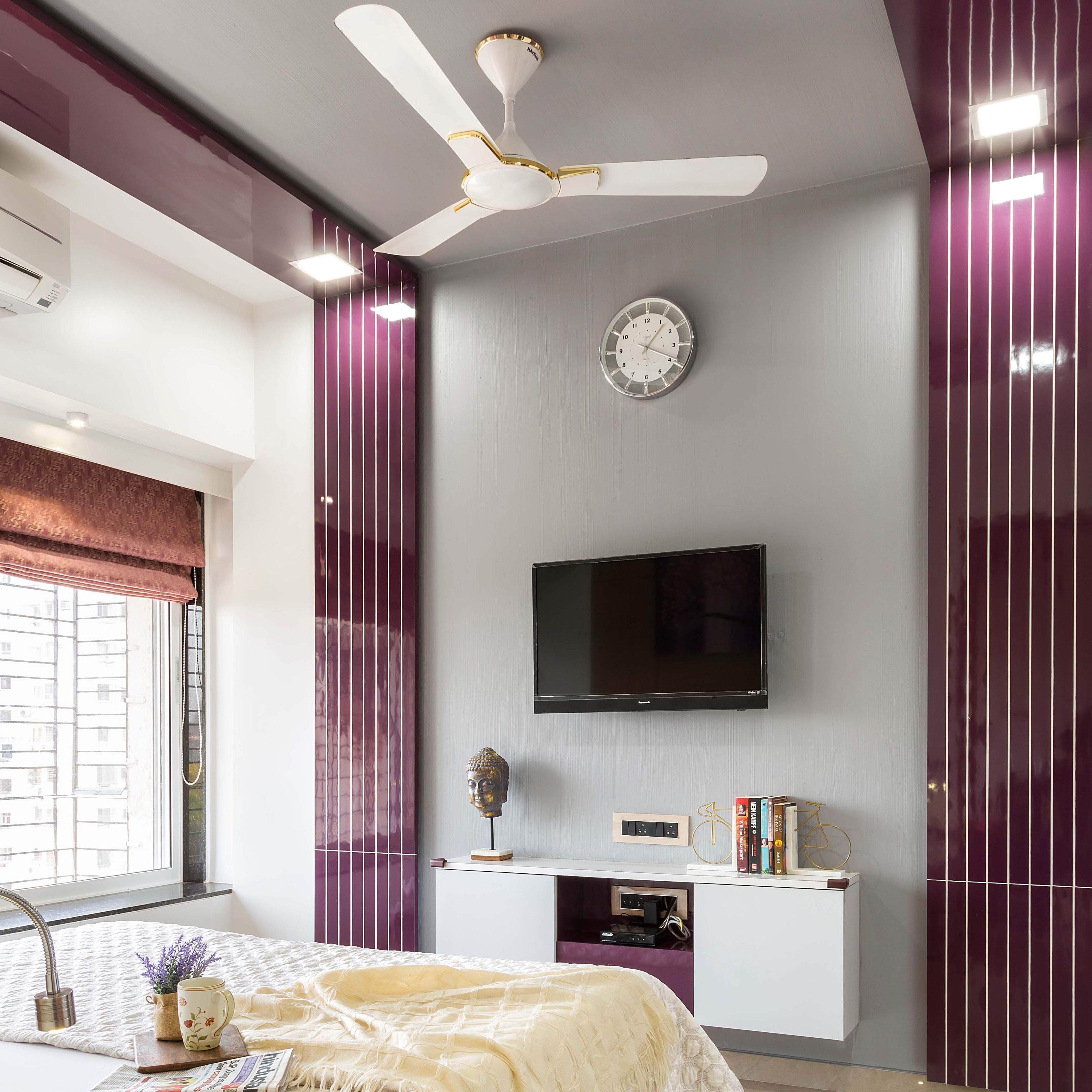 White TV Unit design flanked by purple wall panelling - Livspace