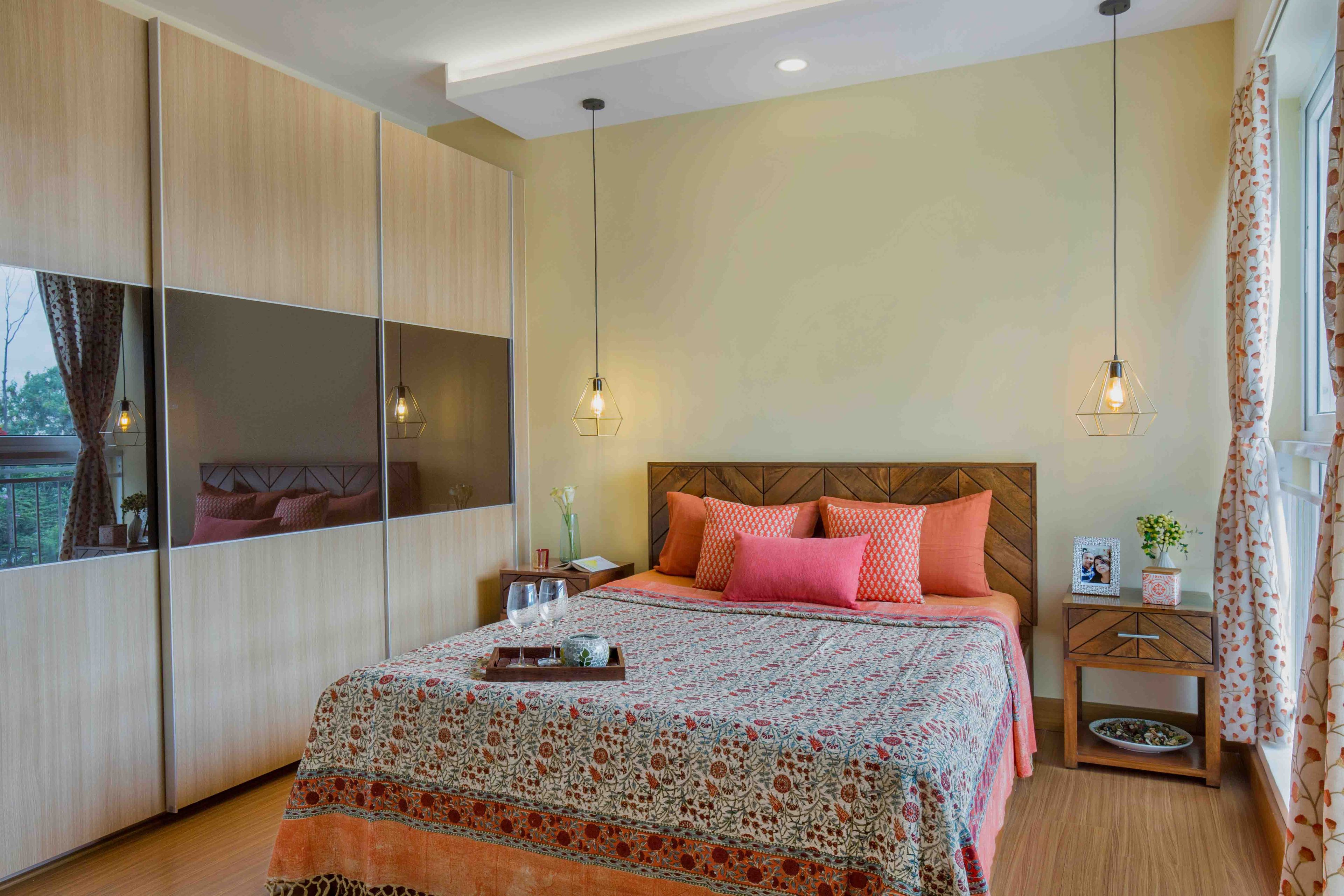 Compact master bedroom design with 3-door wooden sliding door wardrobe - Livspace