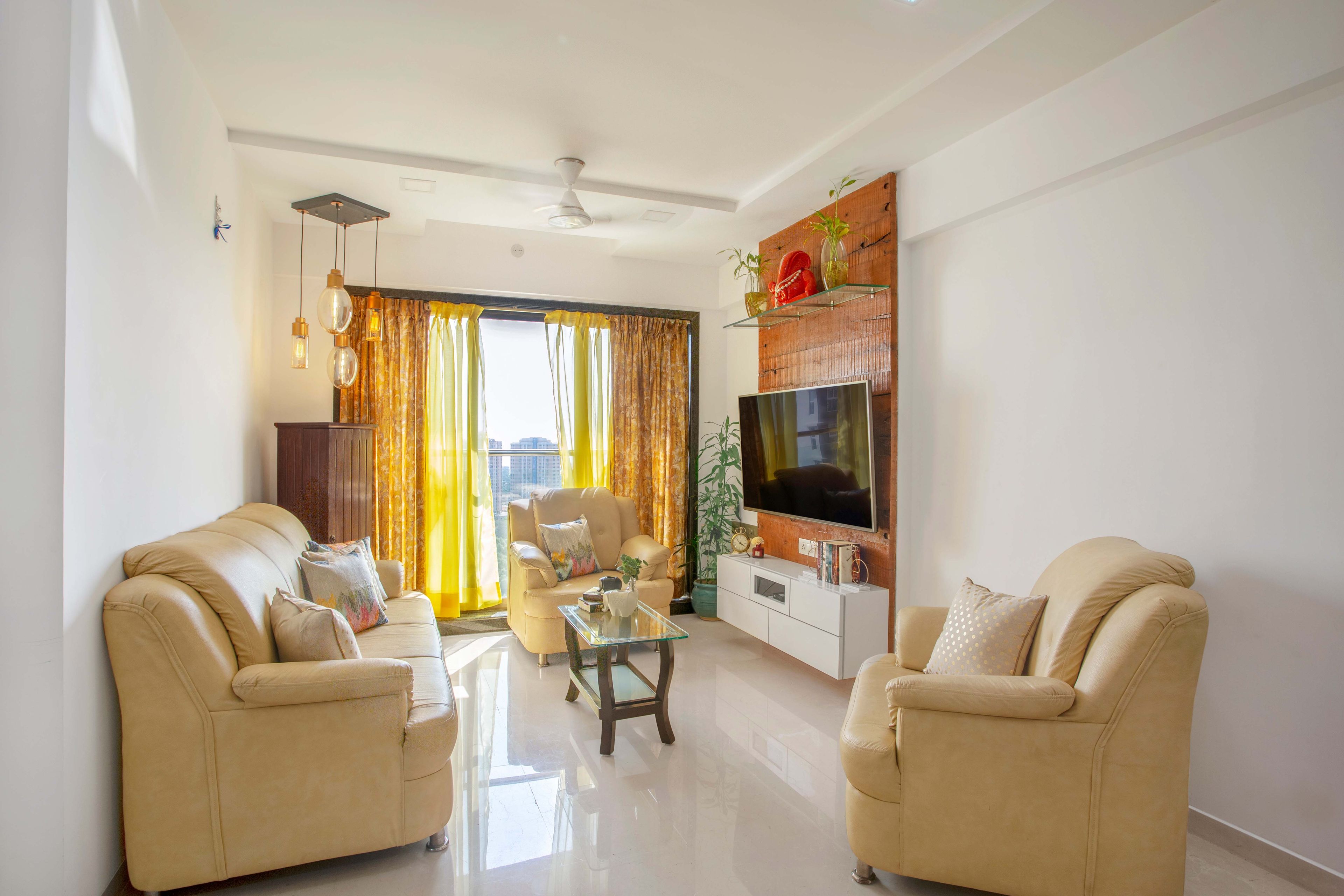Beige U-shaped living room design with wooden TV unit - Livspace