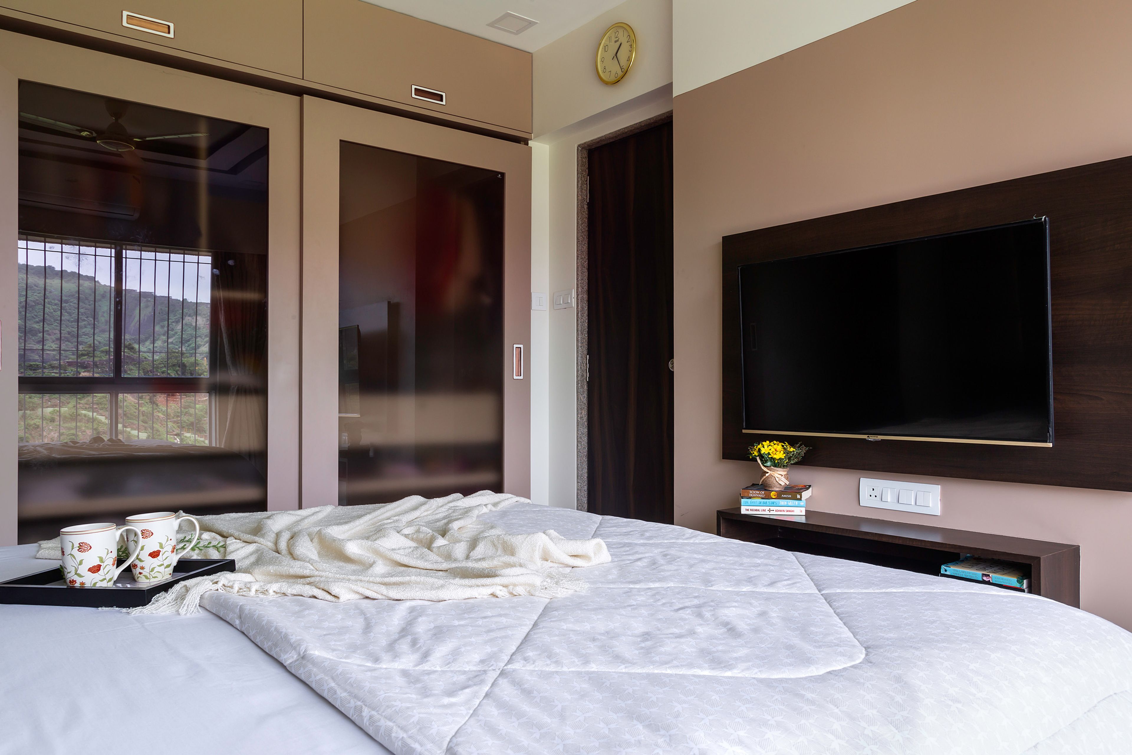 Dusty rose sliding wardrobe design with translucent shutters and loft - Livspace
