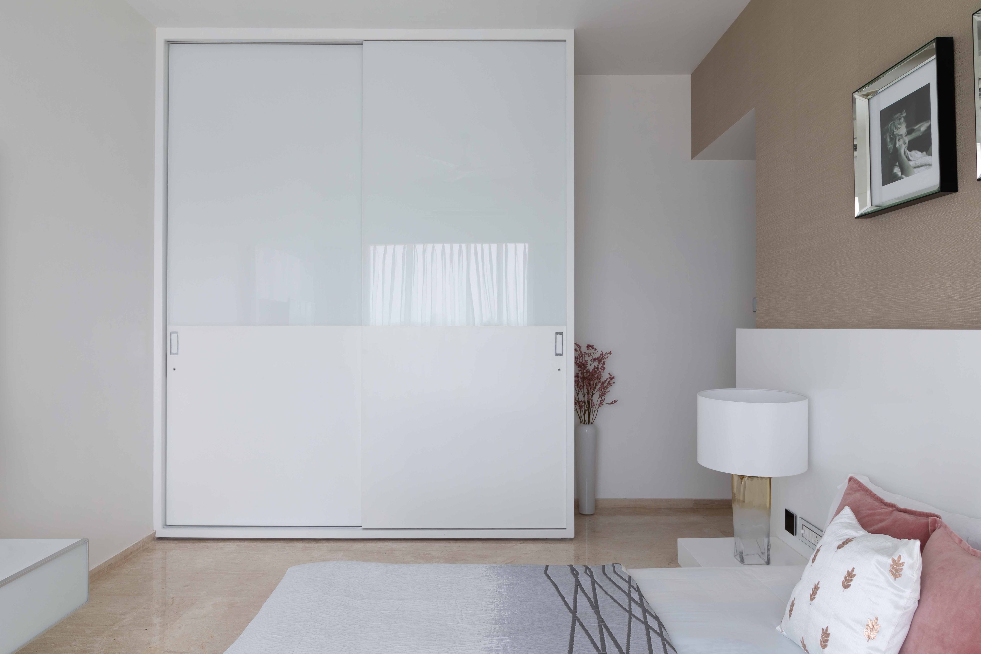 White sliding wardrobe design for the master bedroom - Livspace