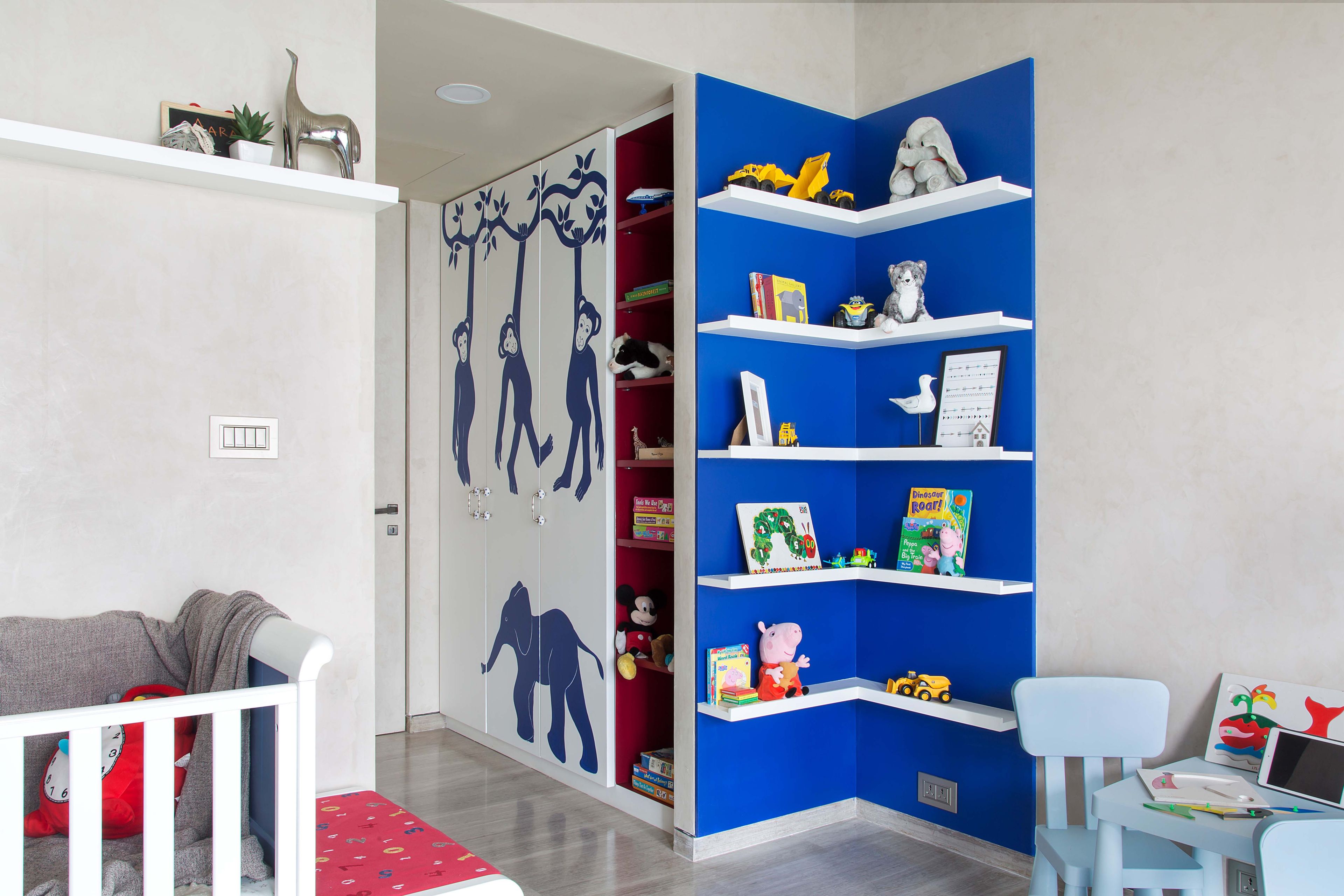 3-door swing wardrobe design with blue open shelves - Livspace