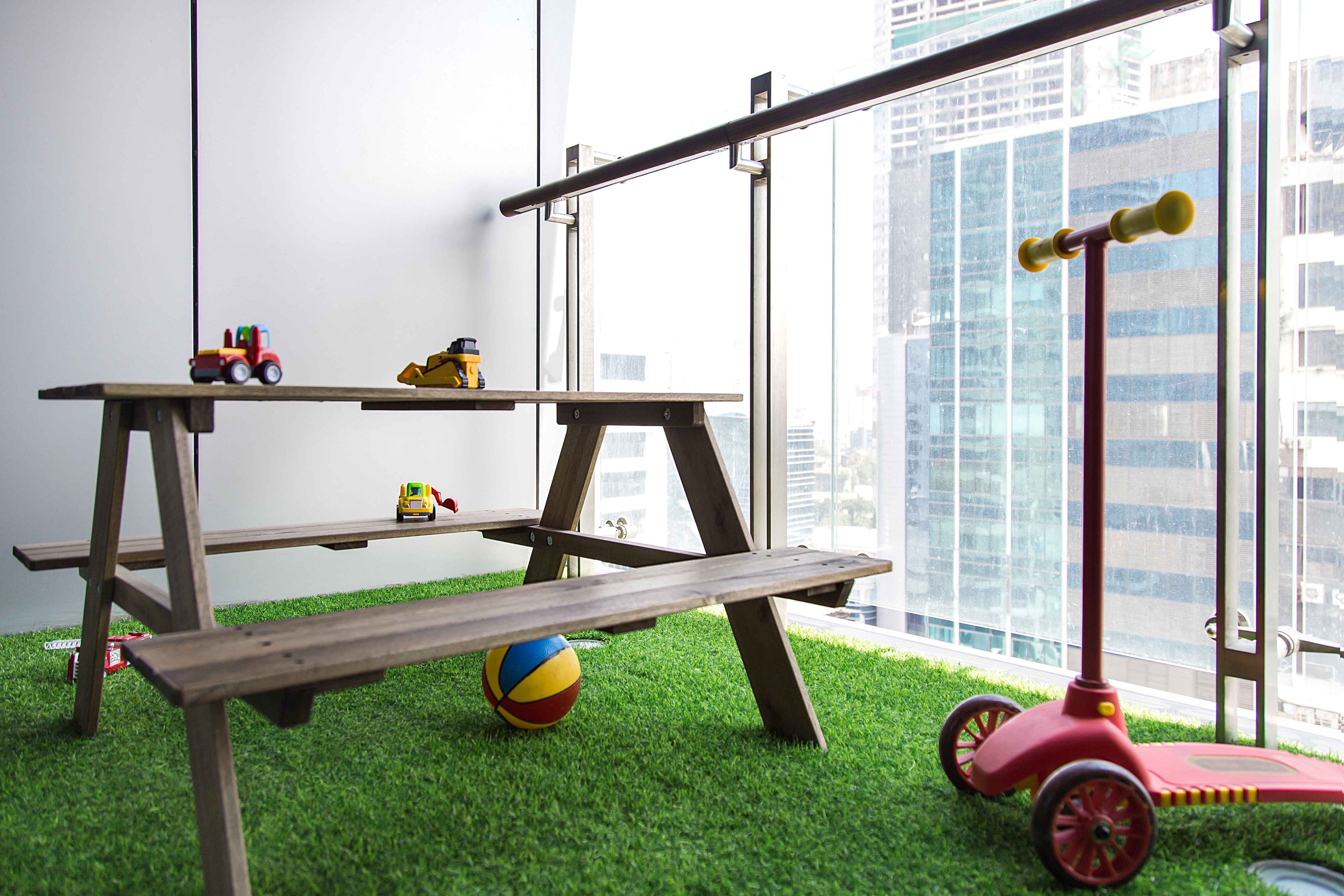 Wooden bench and seater with green grass mat for the balcony - Livspace