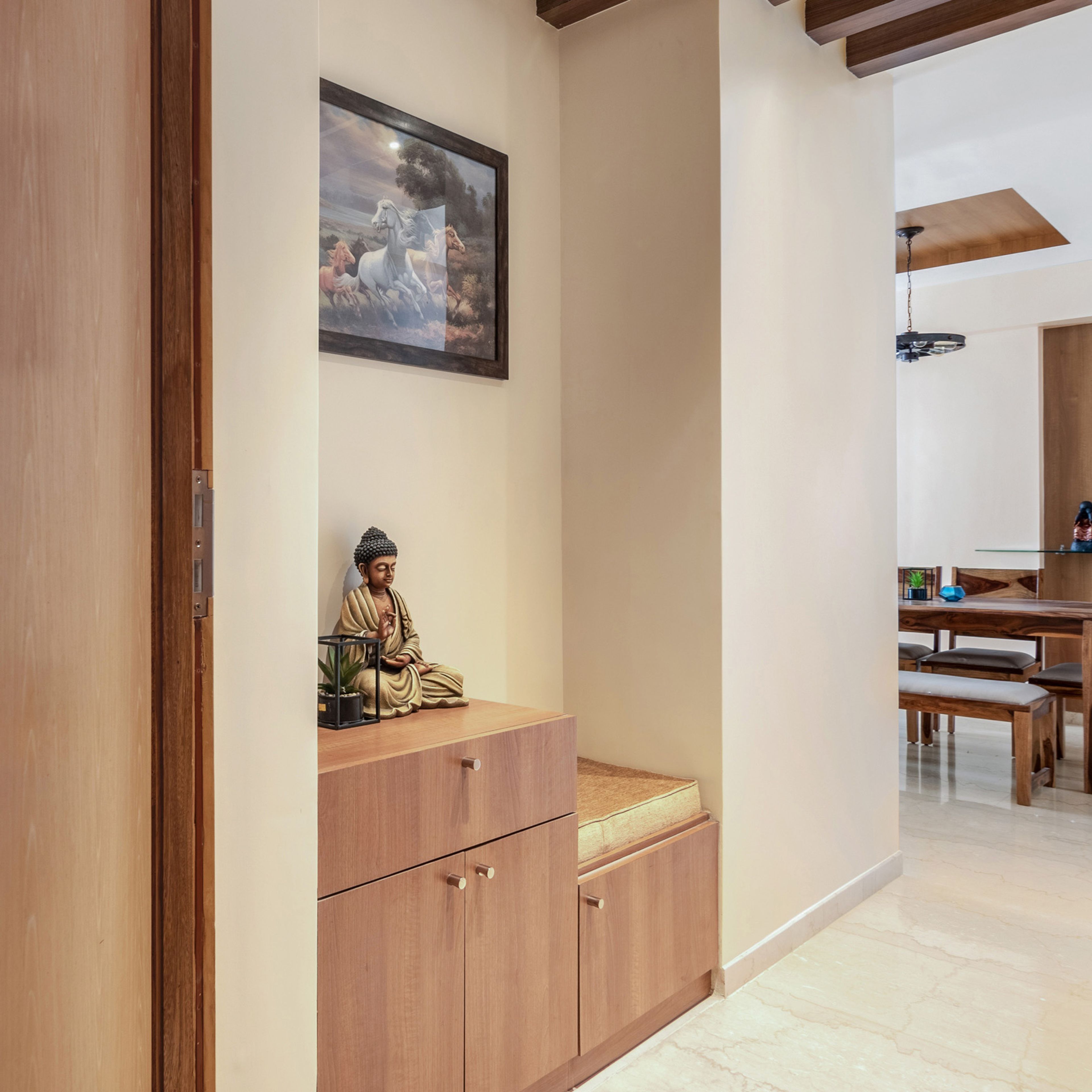 Minimalistic beige and wood foyer design with wooden cabinet storage - Livspace