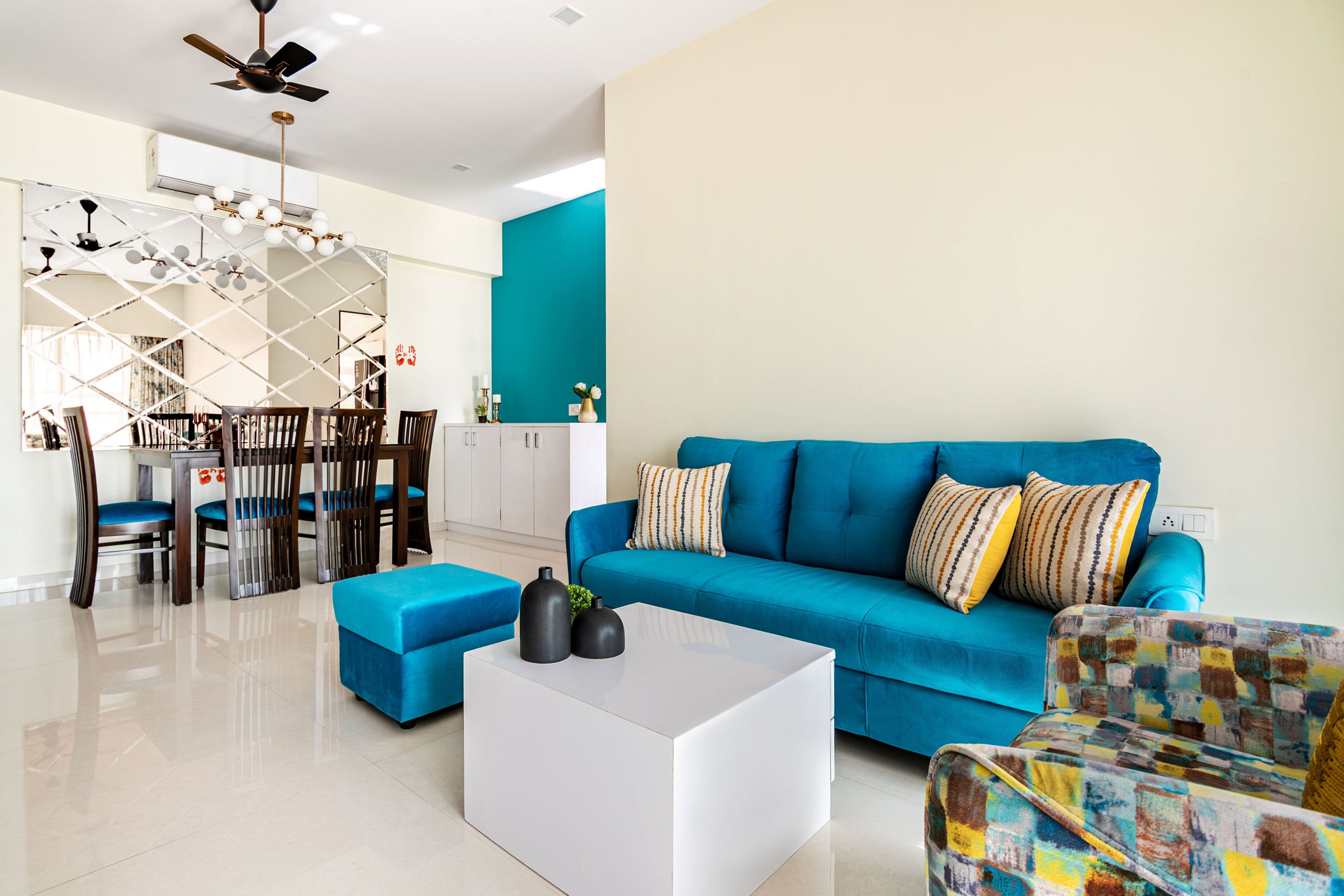 Blue living room design with abstract sofa and white coffee table - Livspace