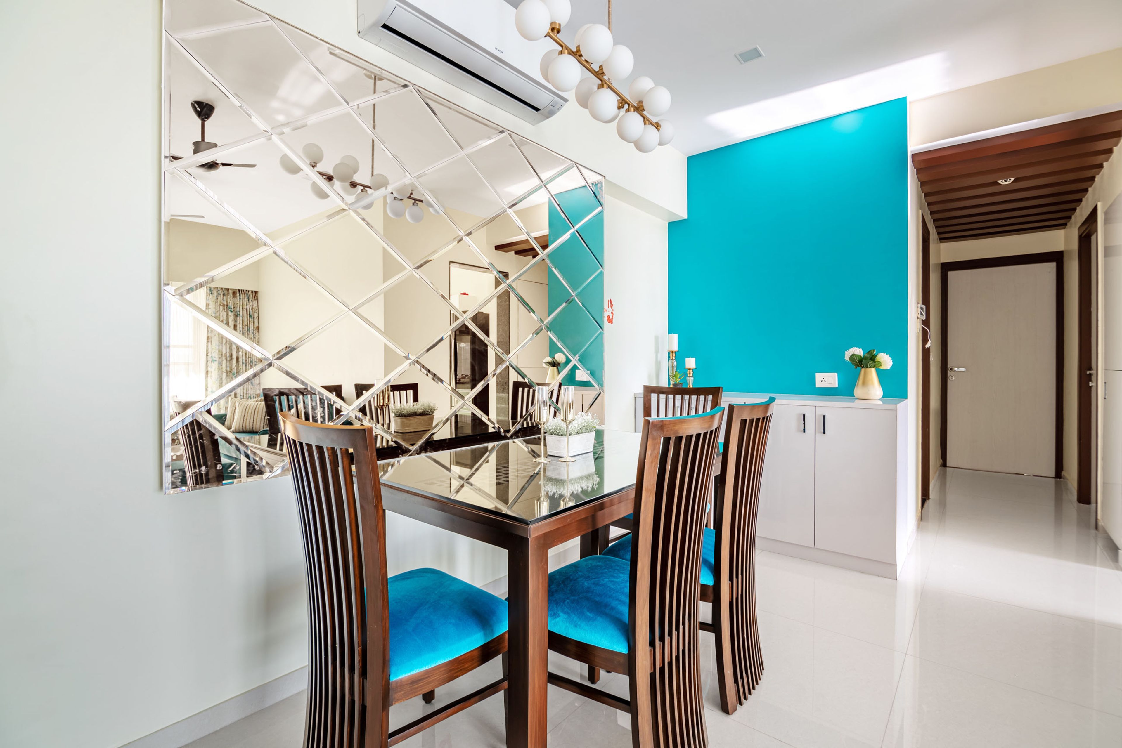 4-seater wood and glass dining room design with glass panel for the wall - Livspace