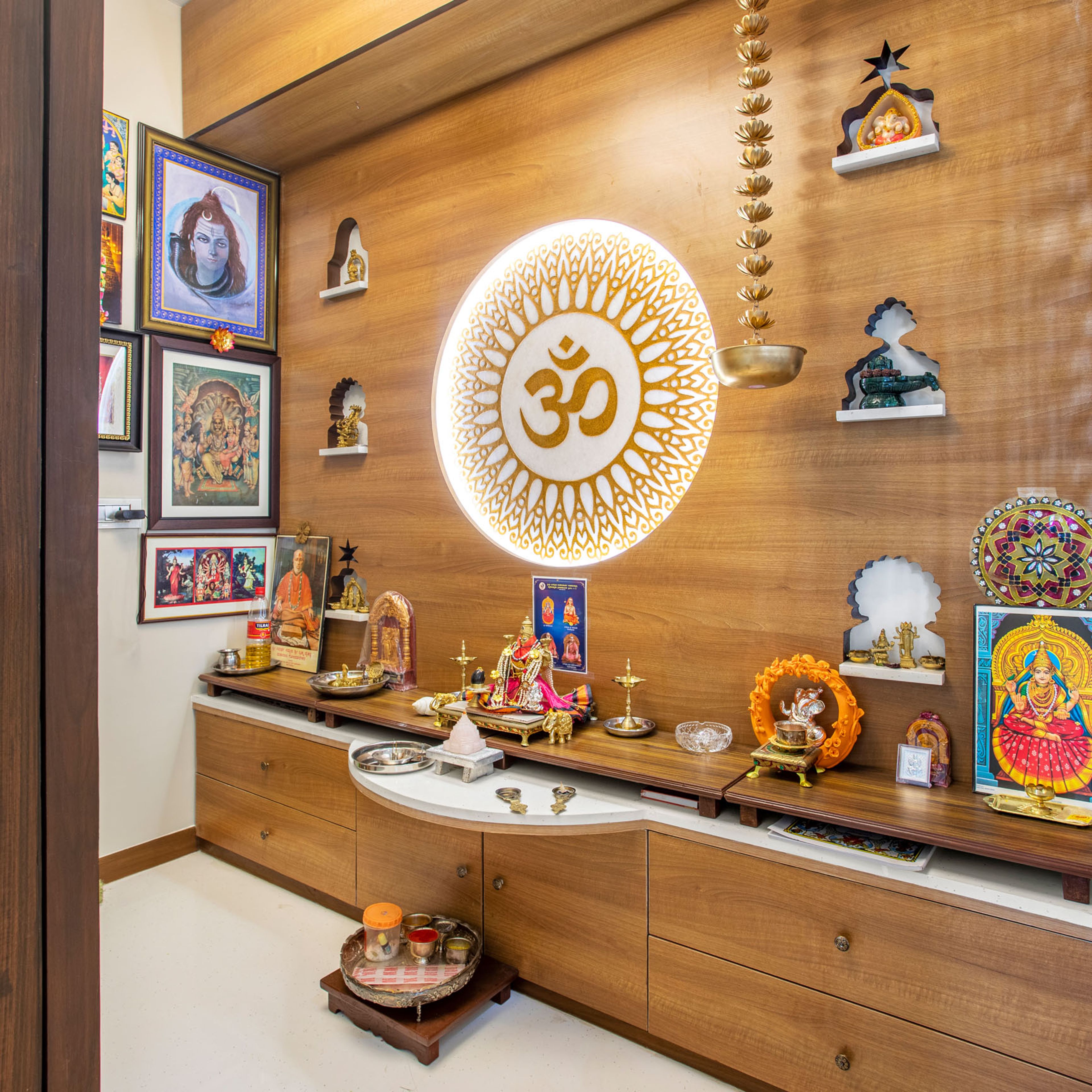 Wooden pooja room unit with 'Om' pattern - Livspace