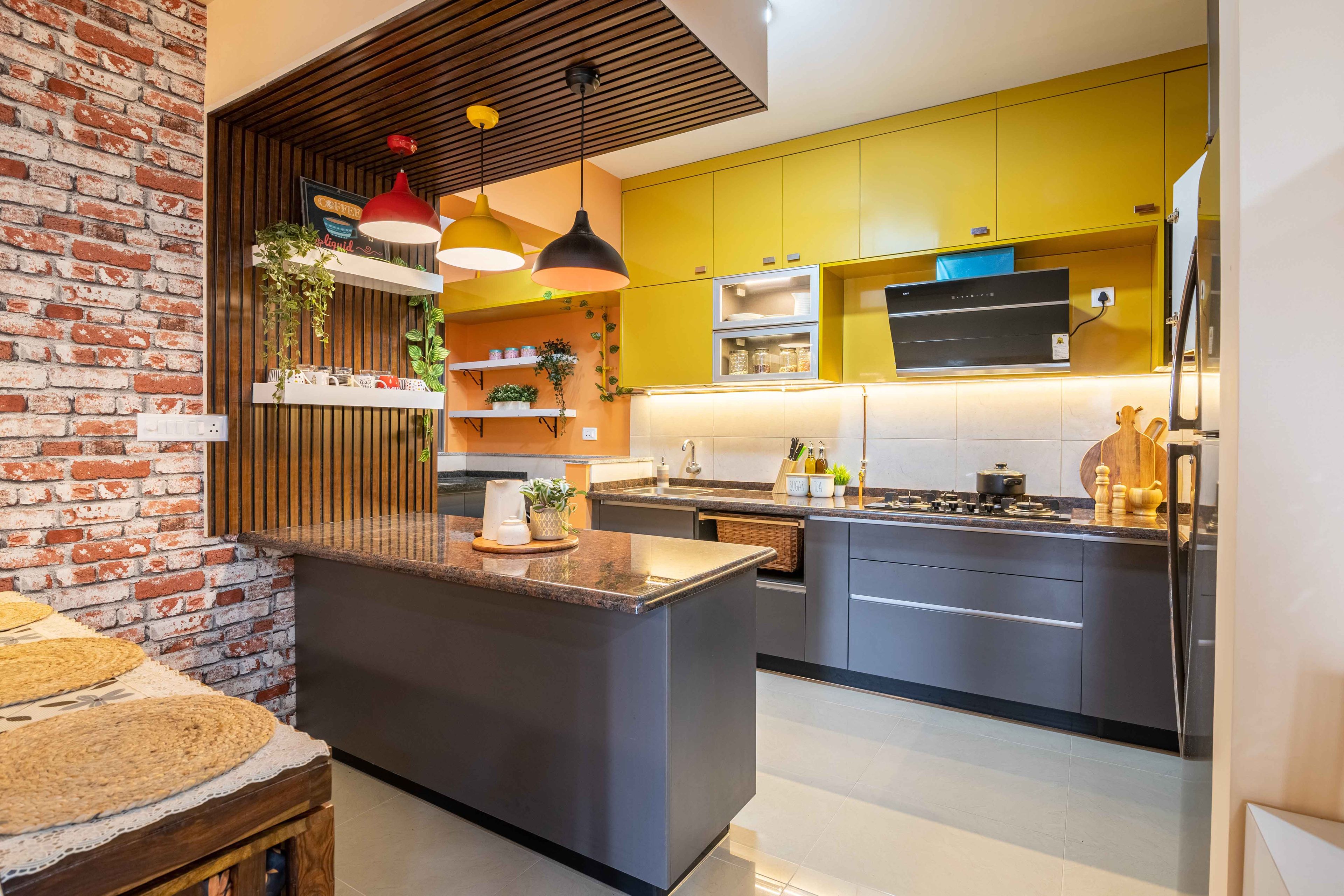 Modern Open Kitchen Design With River Stone and Marigold Yellow Cabinets