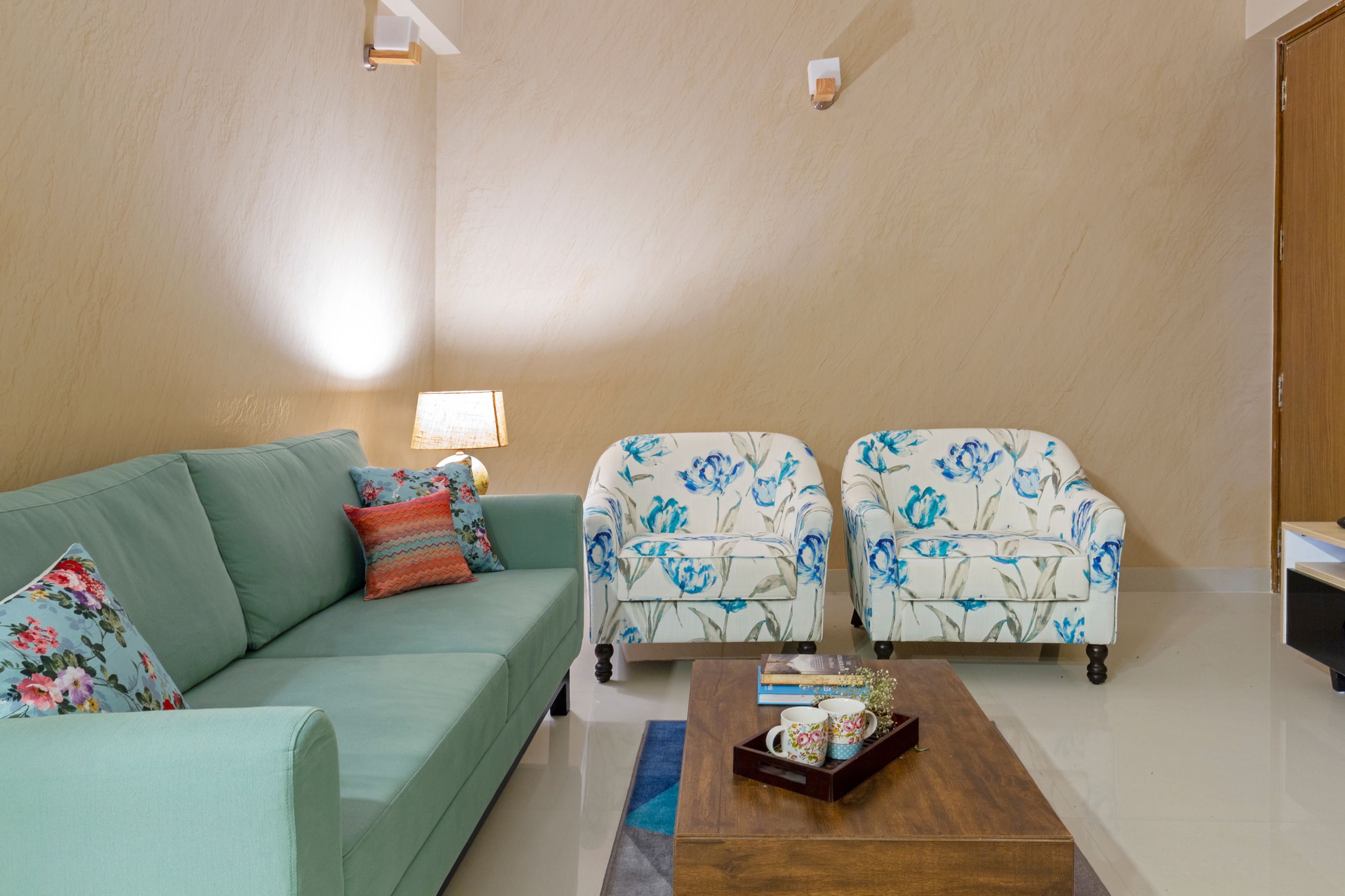 9x9 Ft  Beige Living Room Design With Mint Green Sofa And Floral Accent Chairs - Livspace