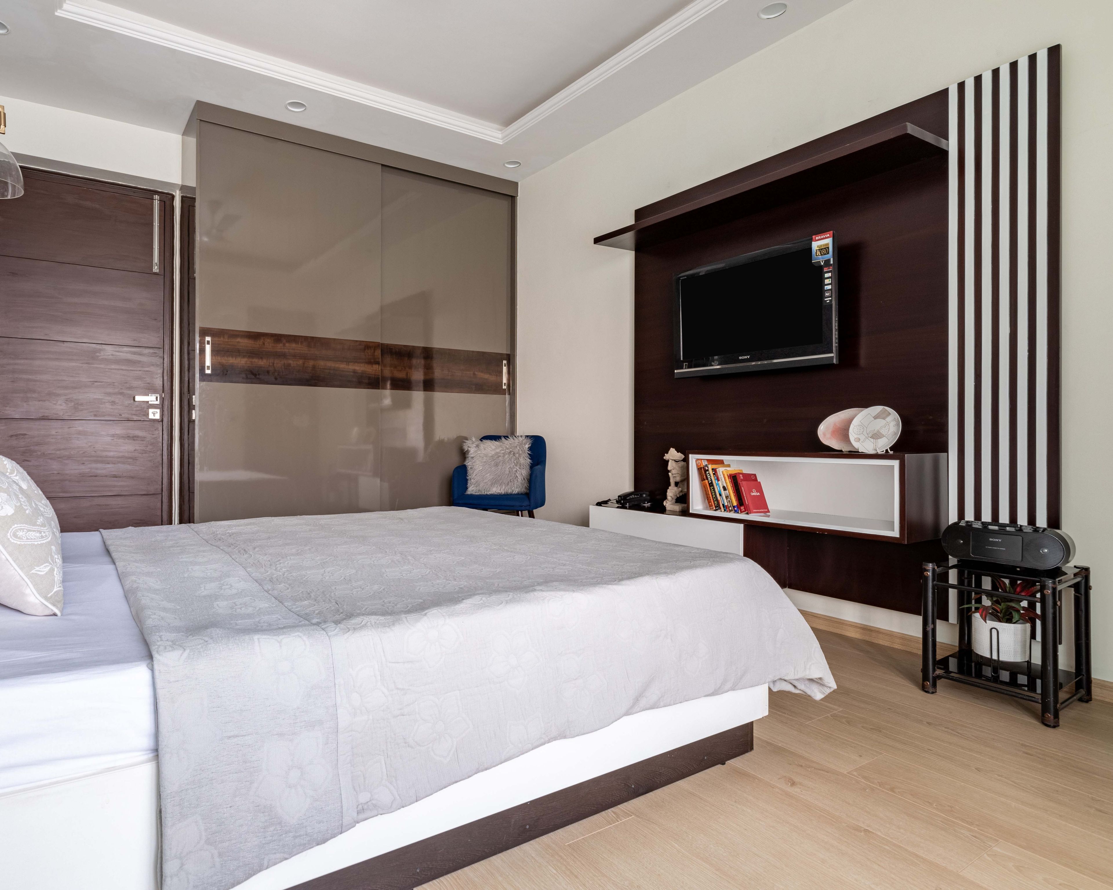 Canadian Walnut And White TV Unit Design With Striped Back Panel - Livspace