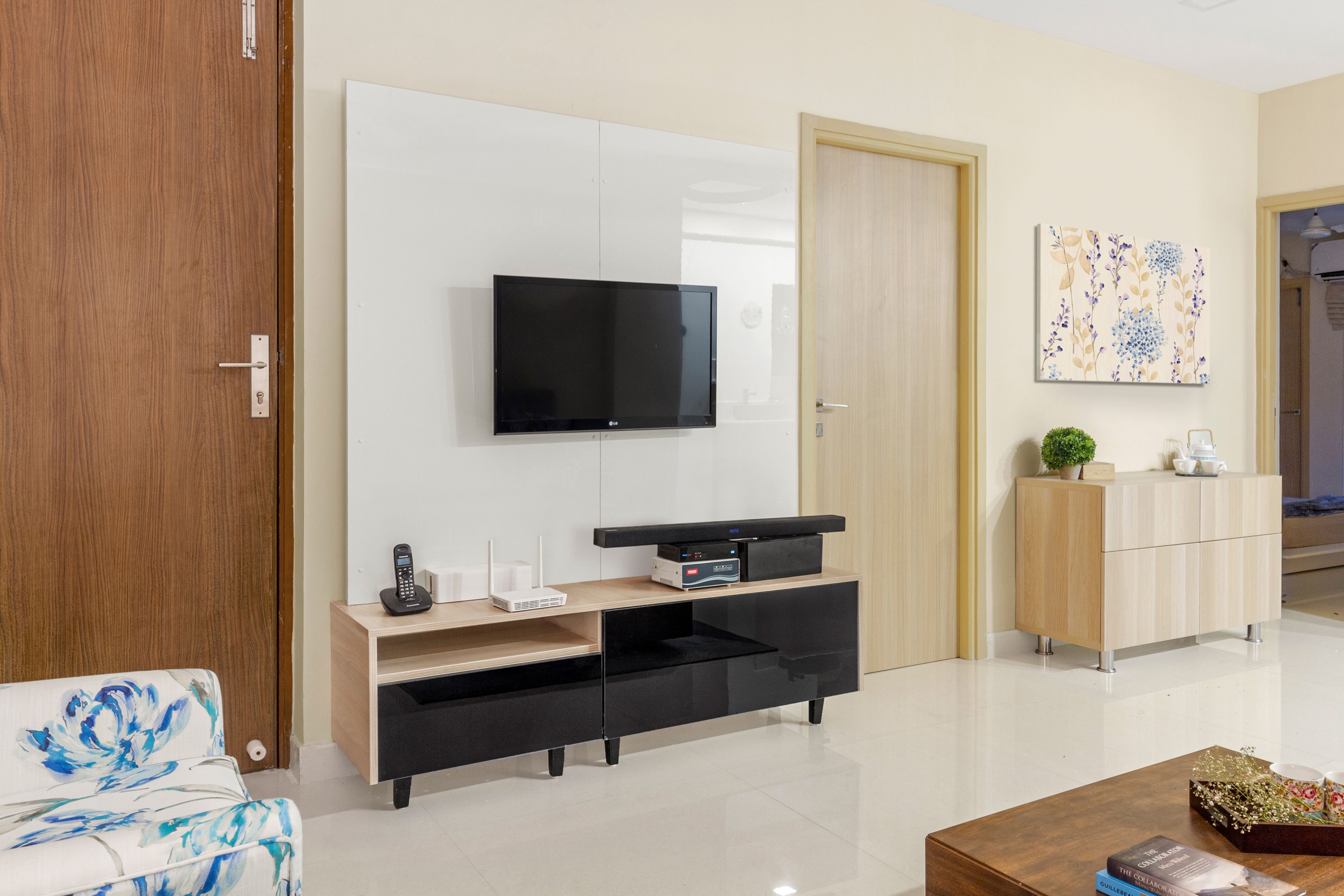 TV Unit Design With A Glossy Black Console - Livspace