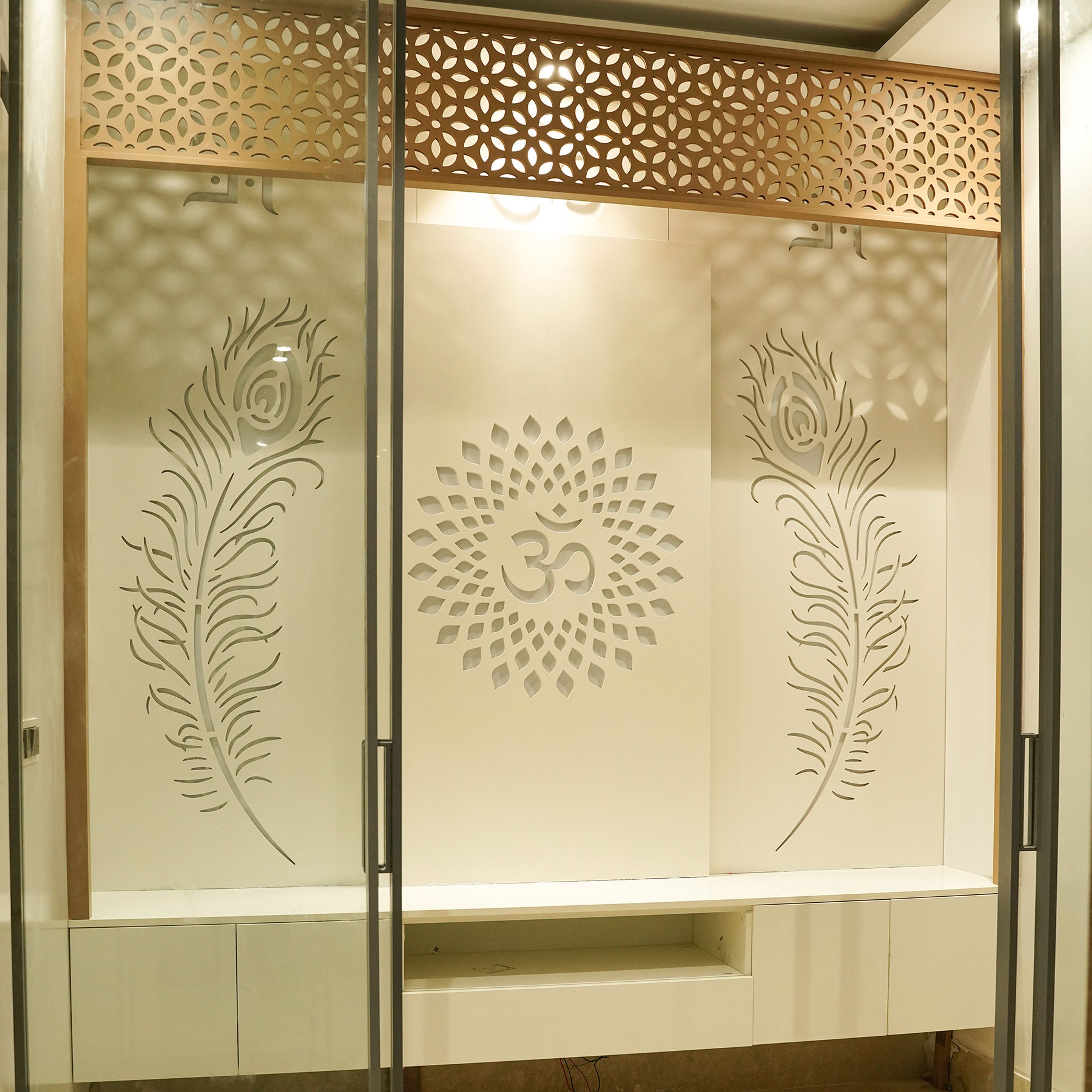 Minimal Pooja Design with Floating Cabinets, Om Motif Backlighting and Lotus Cutwork