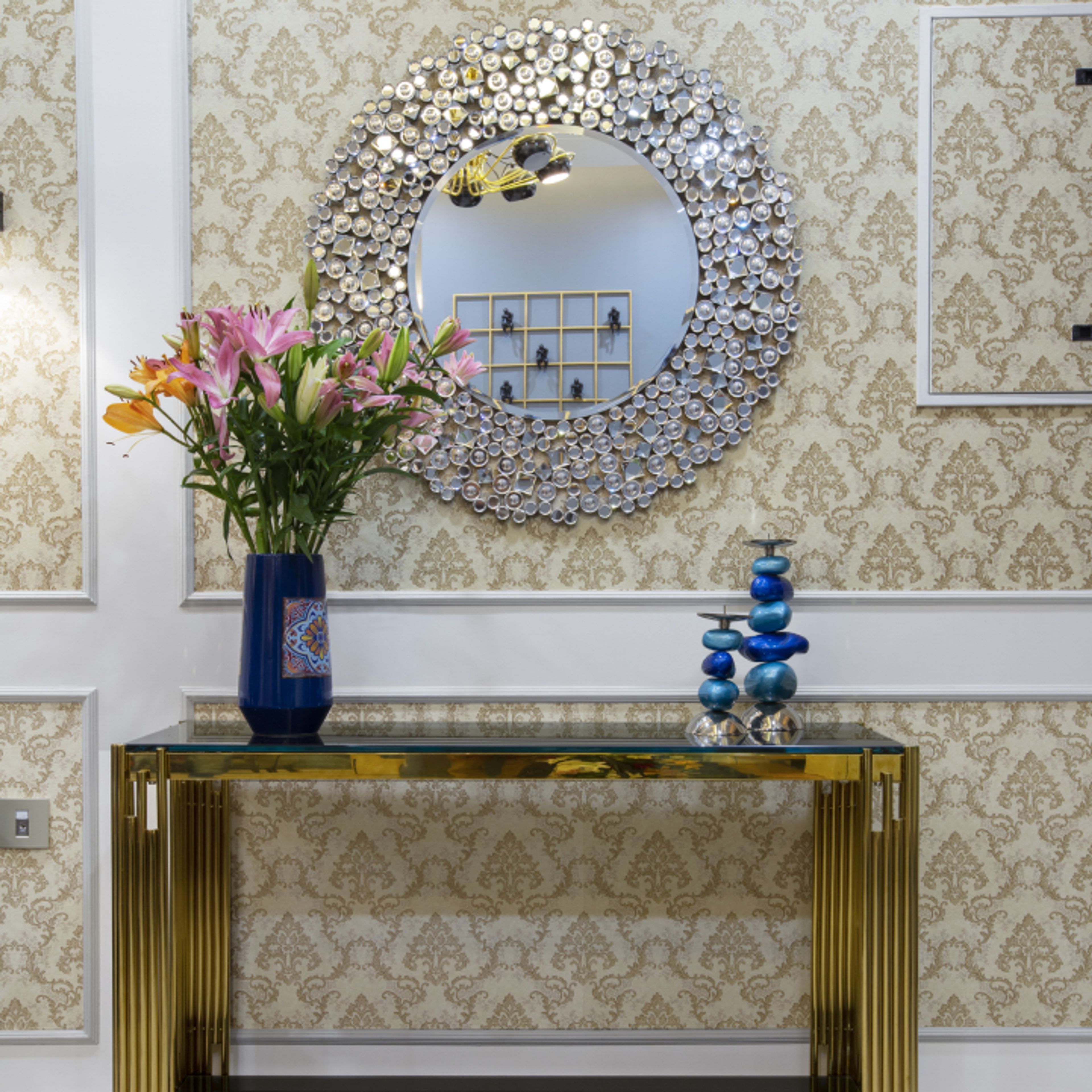 Classic Gold Foyer Design With Wallpaper And Round Mirror
