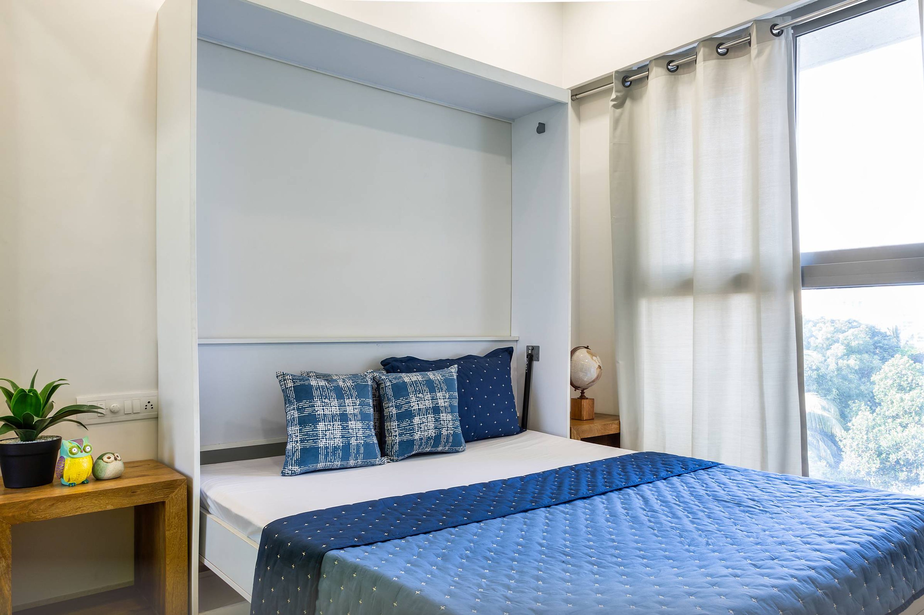 Modern Guest Room Design With White Wall Niche And Blue Upholstery